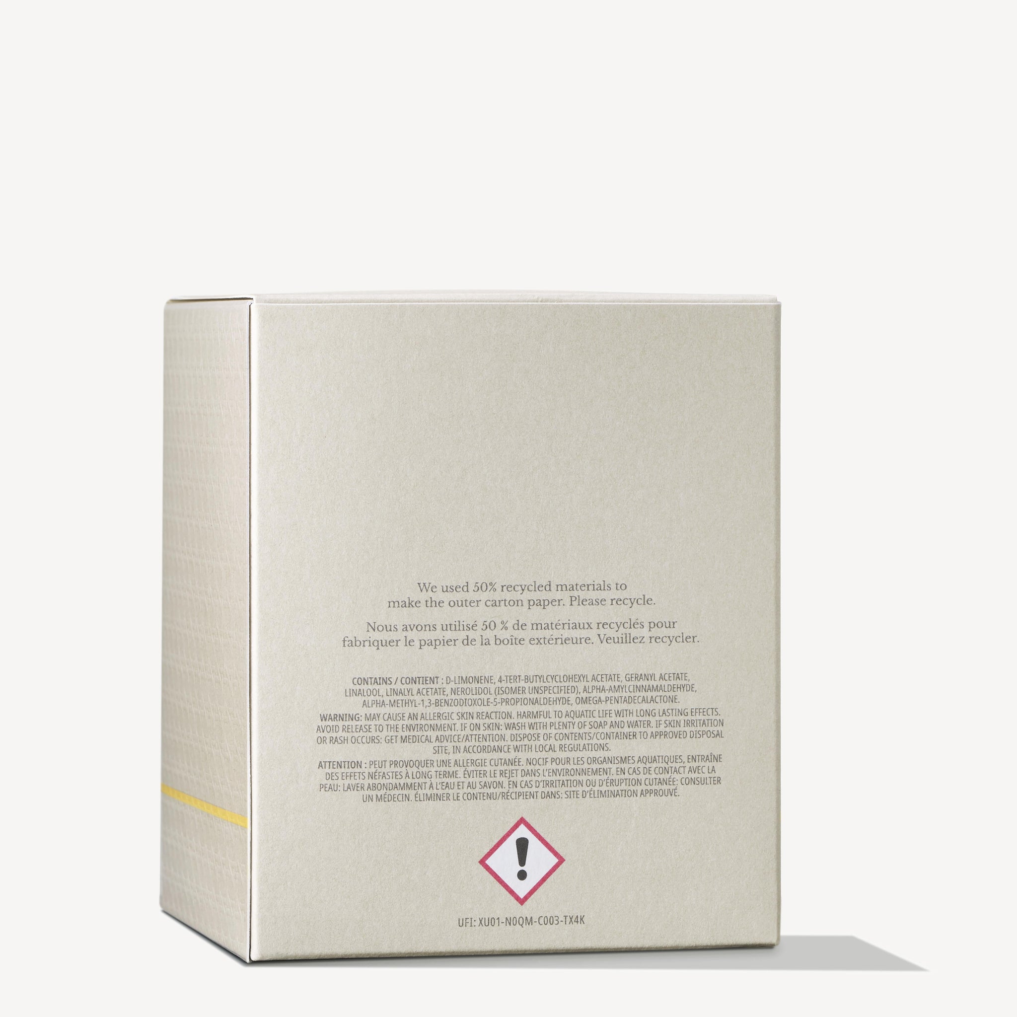The image features a beige cardboard box displaying text and warning symbols on the back. It indicates that the packaging for the MoltonBrown Cyprus Orange & Bergamot Signature Candle 190g, which includes a single wick candle, is made from 50% recycled materials and is recyclable. A caution symbol is noticeable at the bottom.