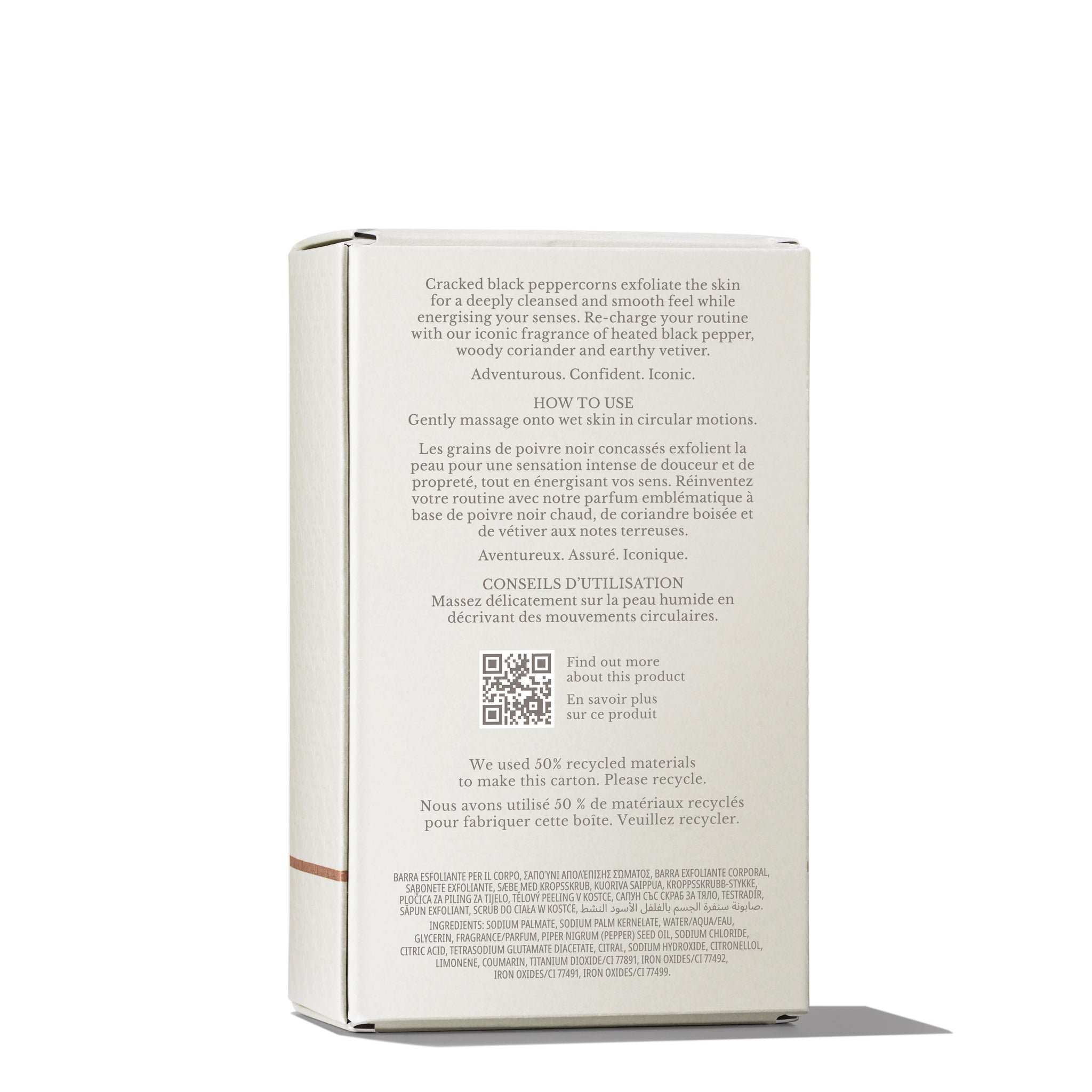 The image showcases the backside of a MoltonBrown Cyprus Re-charge Black Pepper Bodyscrub Bar 250g box, highlighting its ingredients and usage instructions. The box is positioned upright and features clear text describing its exfoliating properties, enriched with Madagascan black peppercorn oil and crafted from recycled materials.