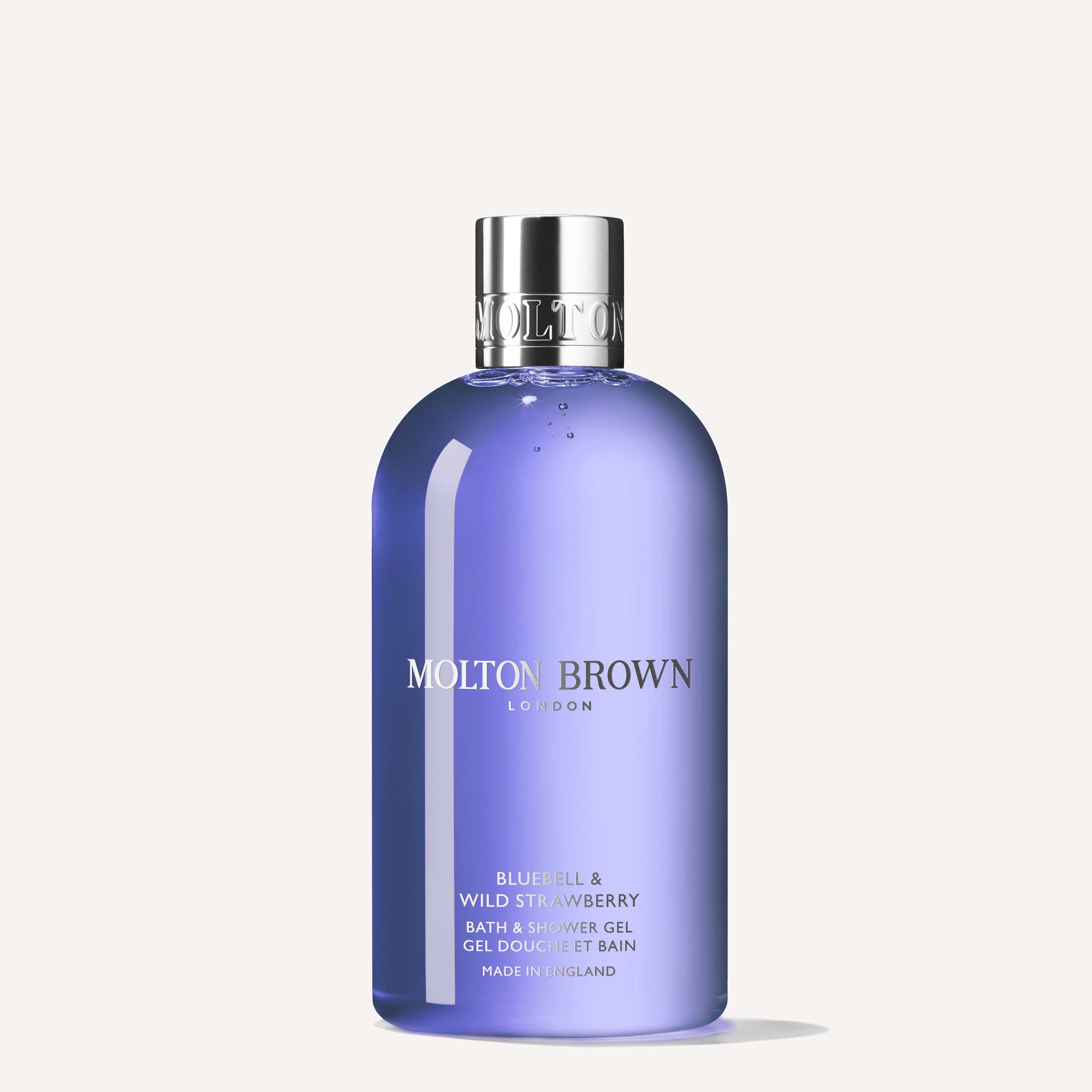 The MoltonBrown Cyprus Bluebell & Wild Strawberry Bath & Shower Gel 300ml offers a floral-fruity body wash experience, captured in a translucent purple bottle with a shiny silver cap and white text, evoking the essence of wild strawberries in fresh spring woodland air.