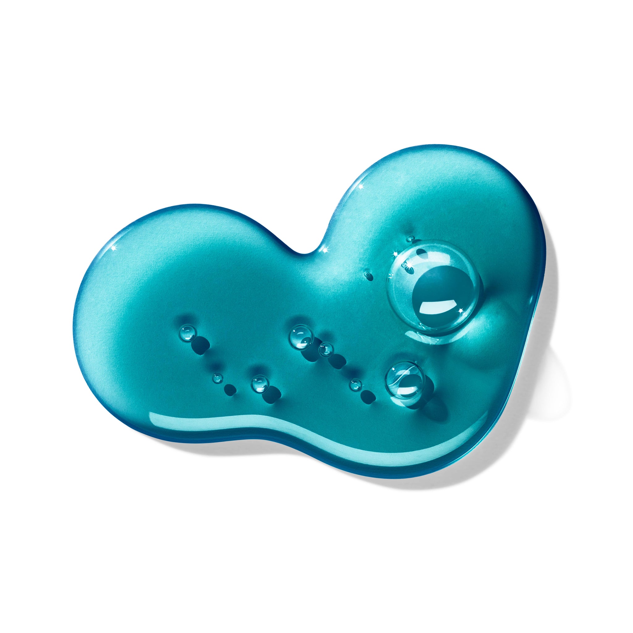 A close-up of a shiny, teal gel blob with multiple small air bubbles inside, forming a smooth, irregular shape against a white background evokes the rich depth found in MoltonBrown Cyprus's Dark Leather Bath & Shower Gel 300ml.
