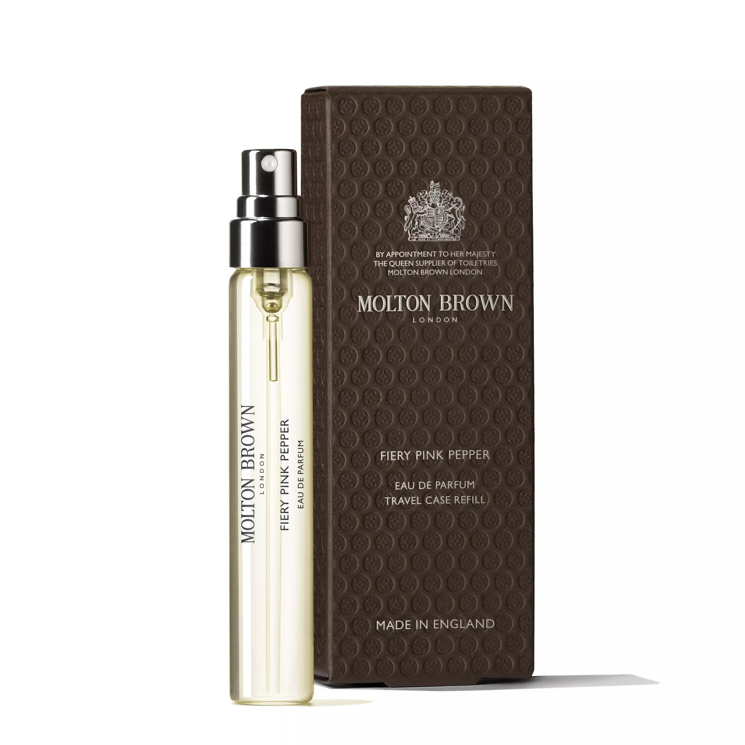 A transparent spray bottle labeled "Sample 1" by MoltonBrown Cyprus, infused with spicy pink pepper, is placed next to a textured brown box. The sleek and elegant design of the bottle alongside its packaging suggests a sophisticated and bold fragrance experience.