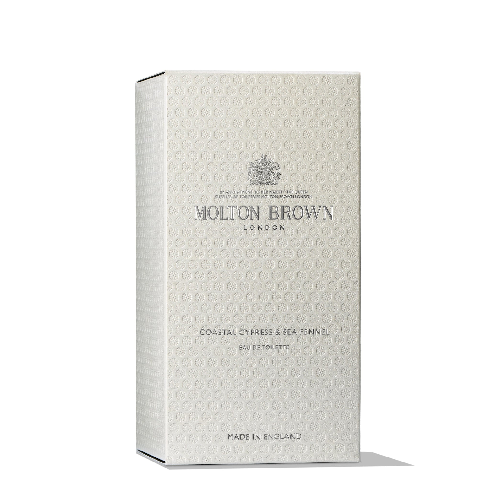 The image features a MoltonBrown Cyprus box in beige, labeled Coastal Cypress & Sea Fennel Eau de Toilette 100ml. It is adorned with the classic logo and embossed patterns, exuding elegance and cedarwood sophistication. Crafted in England, it epitomizes refined branding.