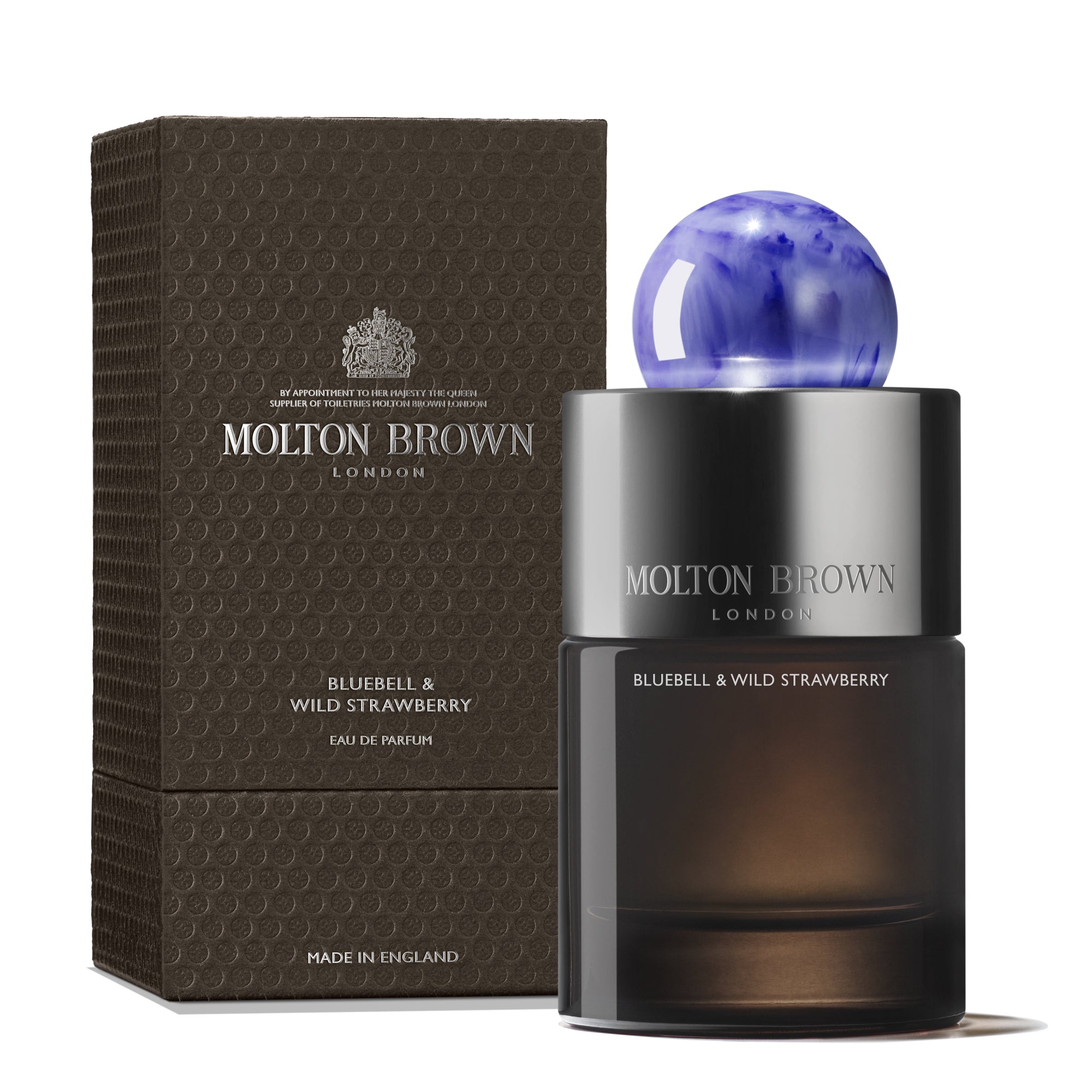 The 100ml Bluebell & Wild Strawberry Eau de Parfum by MoltonBrown Cyprus features a floral-fruity aroma, elegantly presented with a blue spherical cap and housed in a textured dark brown packaging, showcasing luxurious design.