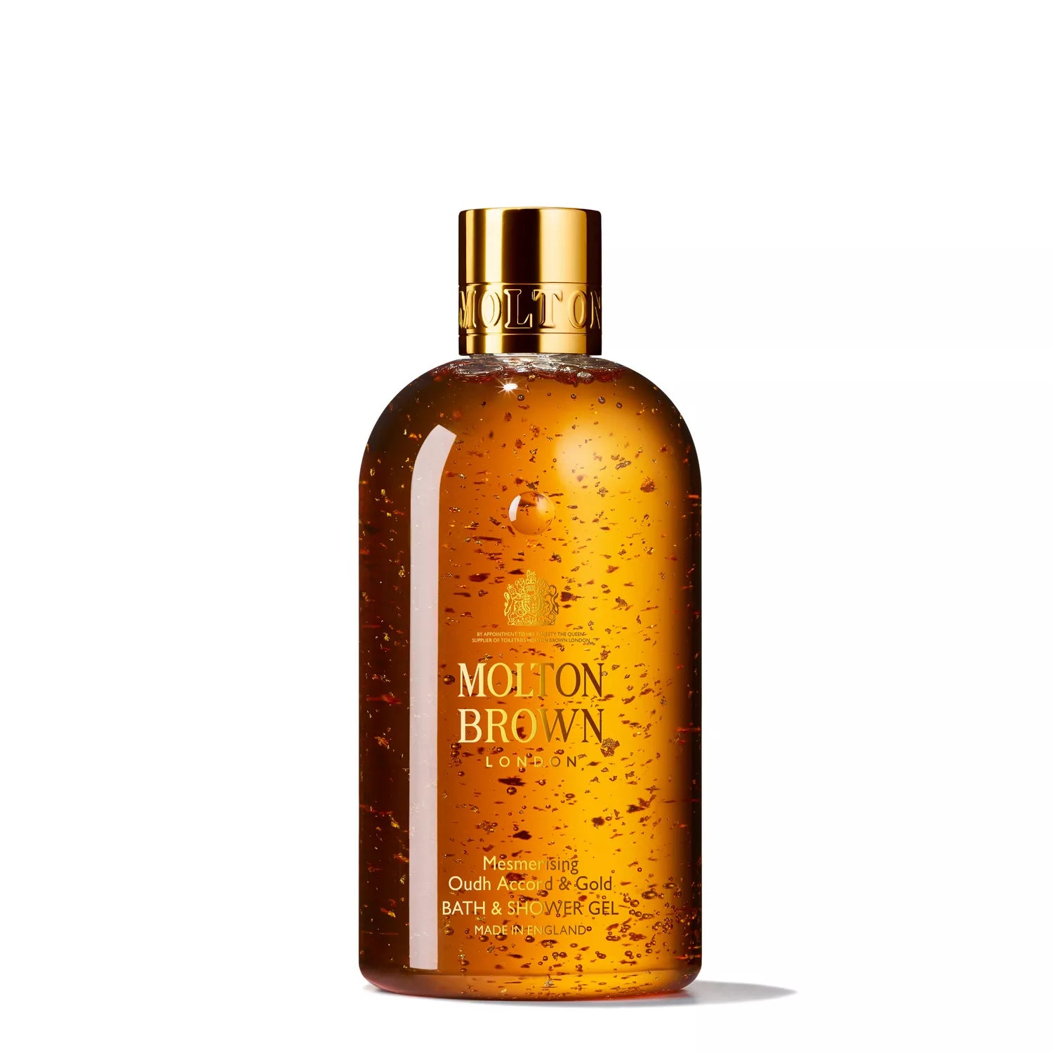 The MoltonBrown Cyprus Woody Gift Set includes a luxurious transparent bottle of golden gel with shimmering particles and a shiny gold cap, showcasing the brand name and product details.