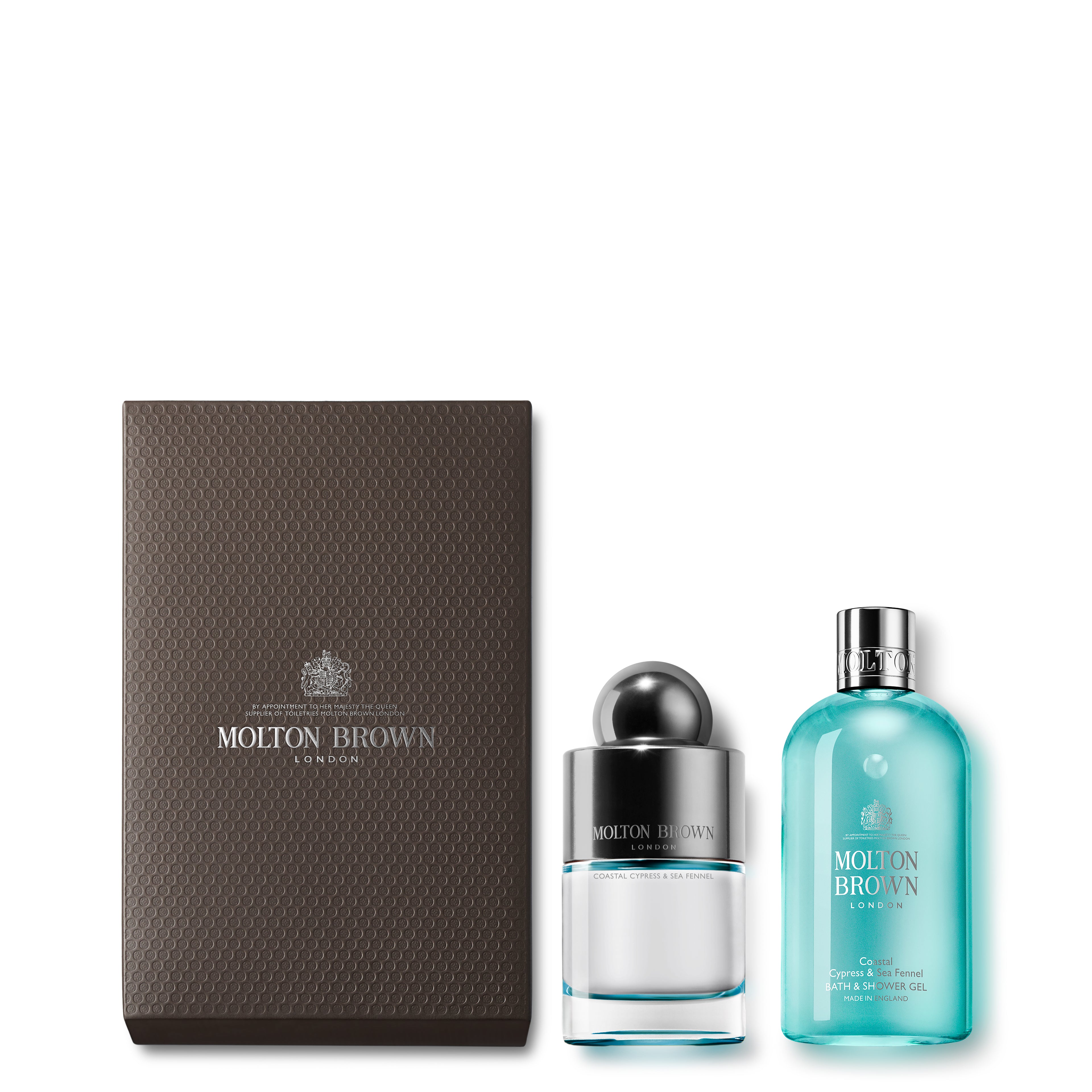 The MoltonBrown Cyprus 100ml Coastal Cypress Fragrance Gift Set features a textured, dark gray box containing the revitalizing Coastal Cypress & Sea Fennel bath & shower gel in a white bottle with a silver cap and an aromatic Eau de Toilette in a blue liquid bottle. Each item is adorned with the brand's logo for a luxurious presentation.