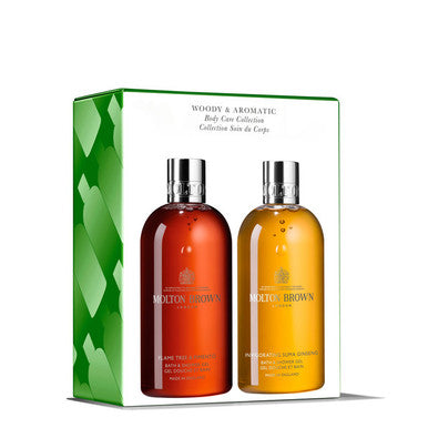 This luxury Woody & Aromatic Body Care Collection set by MoltonBrown Cyprus includes two body washes: a Fiery Pink Pepper with a reddish hue and a Re-charge Black Pepper in a yellowish tone, both enhanced by subtle hints of citrus fruits. The packaging features a green design with heart patterns, adding to its luxurious appeal.