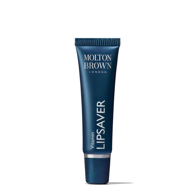 A dark blue tube of Molton Brown Cyprus Vitamin Lipsaver 10ml lip balm with a screw cap, labeled in white text, is enriched with vitamin E and cocoa butter to moisturize and protect lips.