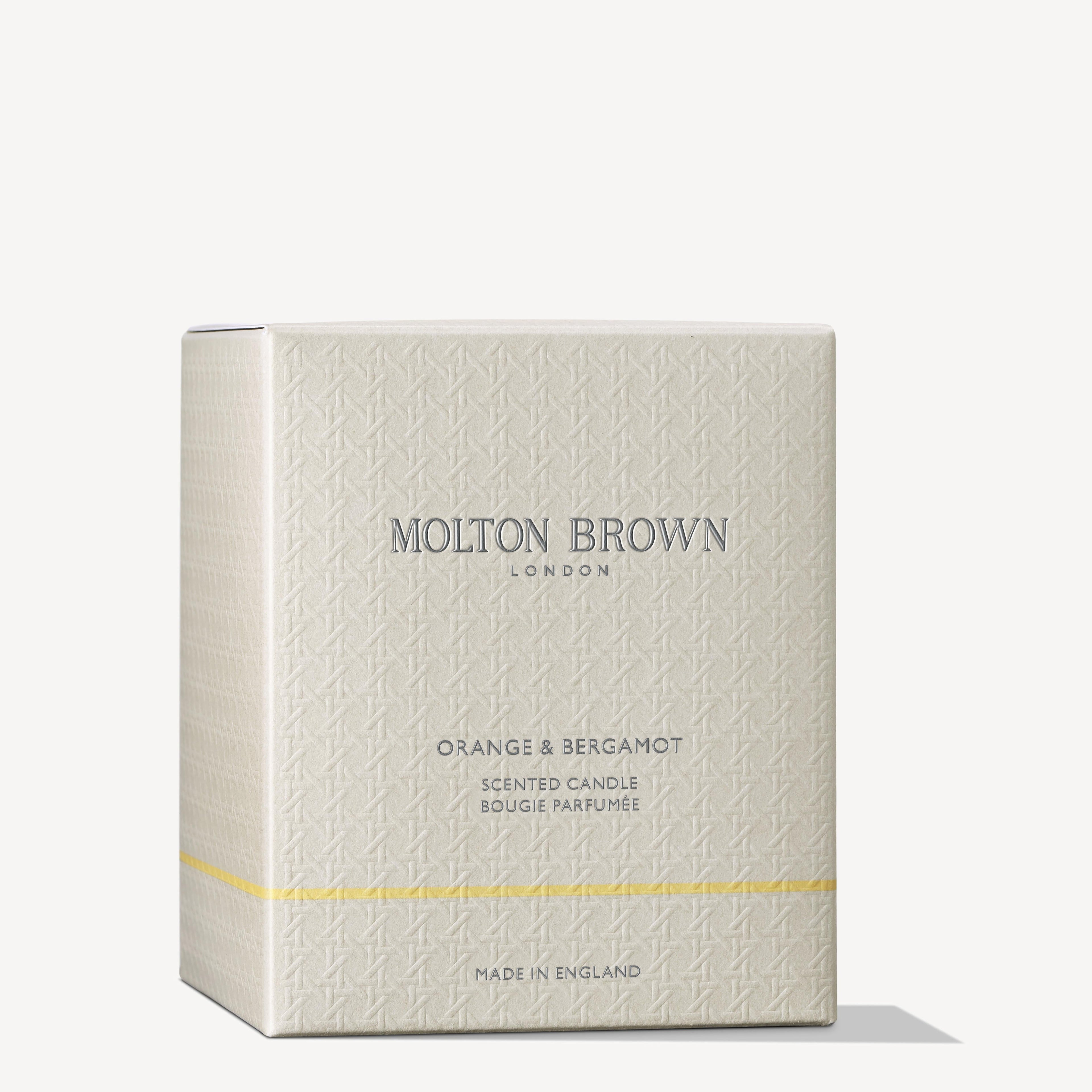 A MoltonBrown Cyprus Orange & Bergamot Signature Candle 190g is packaged in a beige box with a subtle pattern. The box features the text "Made in England" and highlights the orange mandarin fragrance beneath the brand name.