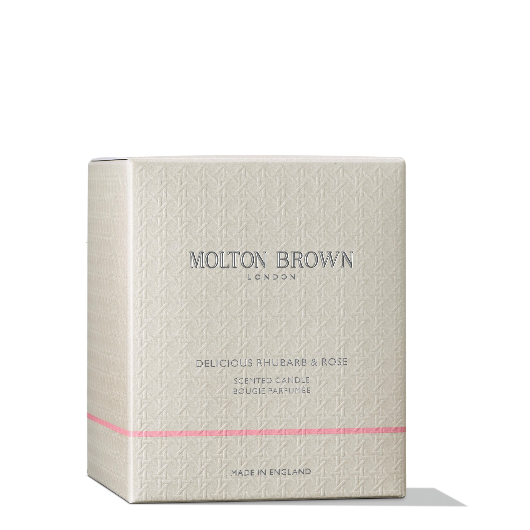 A beige box with a subtle textured pattern showcases MoltonBrown Cyprus and Delicious Rhubarb & Rose Signature Candle 190g on the front. This floral-fruity scented candle, crafted in England, is adorned with delicate pink accents.