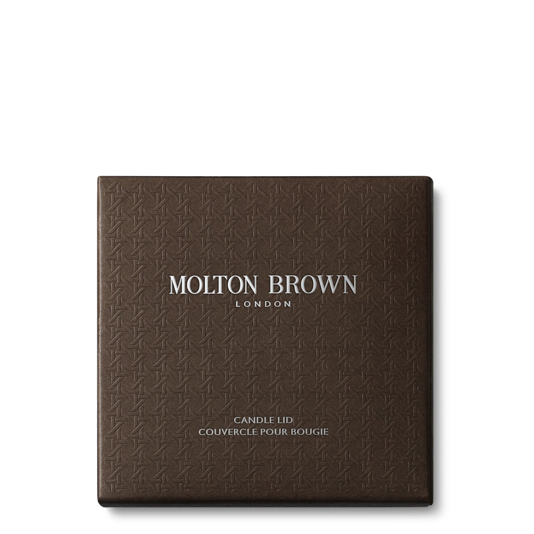 MoltonBrown Cyprus presents the Signature Candle Lid 98g, featuring an embossed pattern and chrome plating. The text on the square brown box reads MOLTON BROWN LONDON, with CANDLE LID COUVERCLE POUR BOUGIE written below. It's a perfect addition to your collection of scented candles.