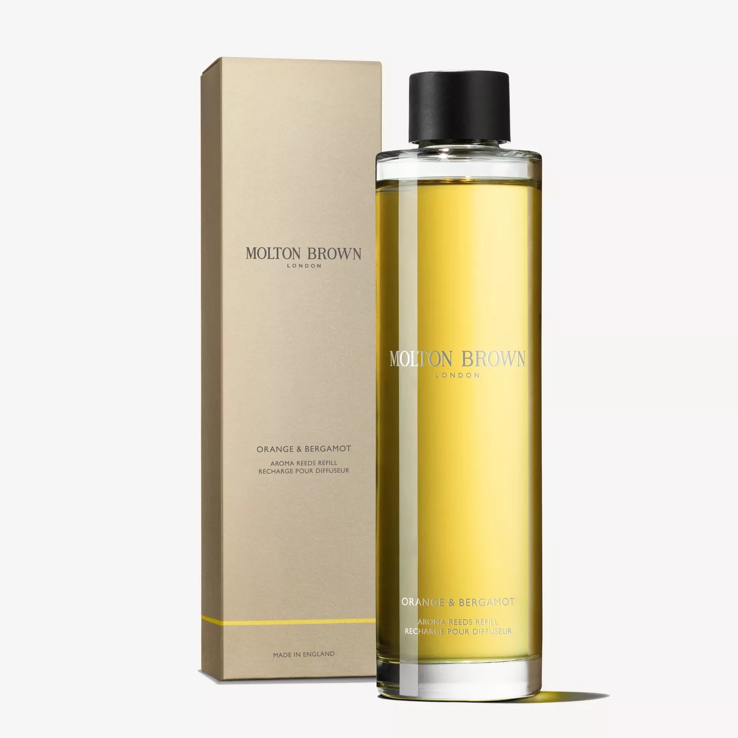A tall, cylindrical bottle filled with yellow liquid labeled MoltonBrown Cyprus stands next to its beige packaging box, offering a delightful citrus home fragrance as the Sample 3 Orange & Bergamot Aroma Reeds Refill.