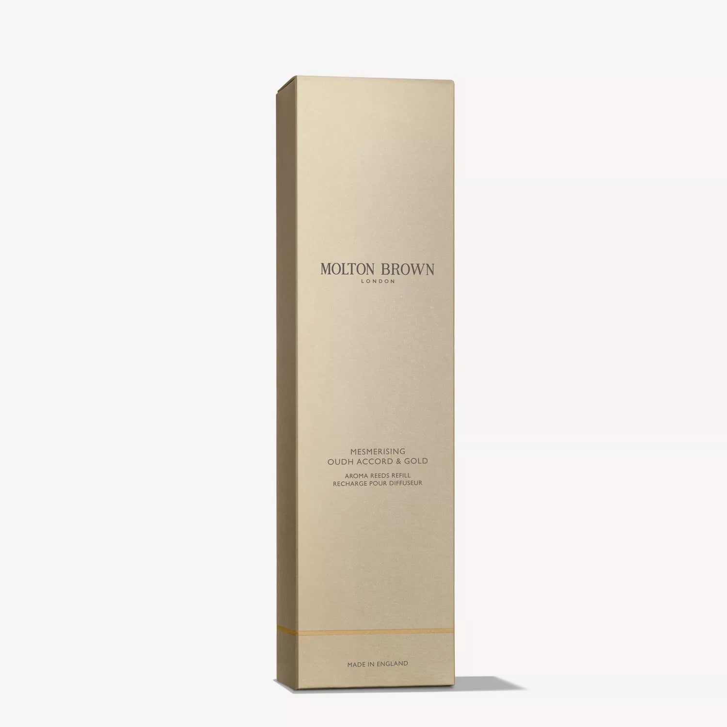 A tall, rectangular gold box labeled MoltonBrown Cyprus Mesmerising Oudh Accord & Gold Aroma Reeds Refill 150ml stands upright against a plain white background, ideal for enhancing your home fragrance experience.