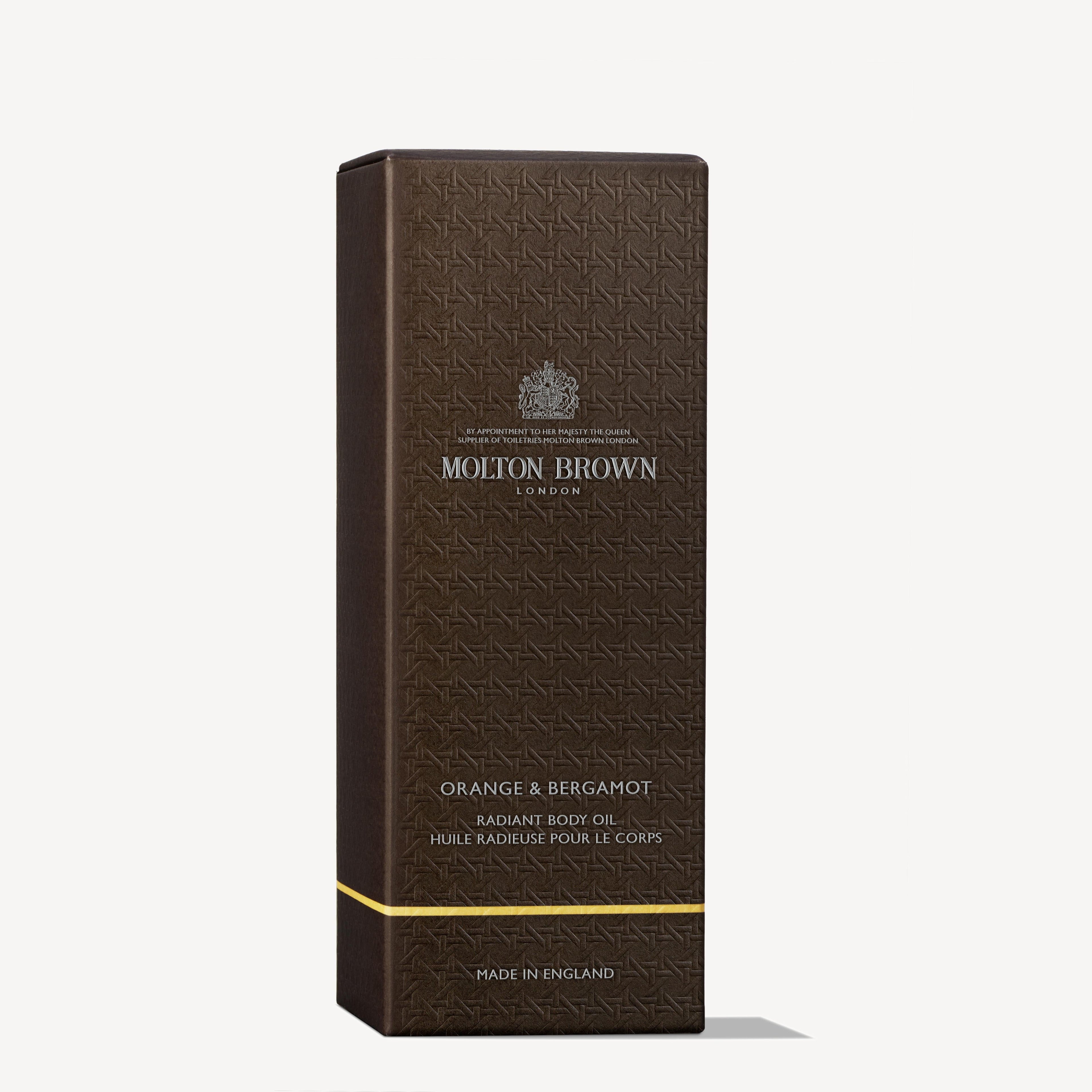 A dark brown rectangular box with an embossed pattern, labeled MoltonBrown Cyprus, containing Orange & Bergamot Radiant Body Oil 100ml. The box features English and French text and indicates Made in England at the bottom.