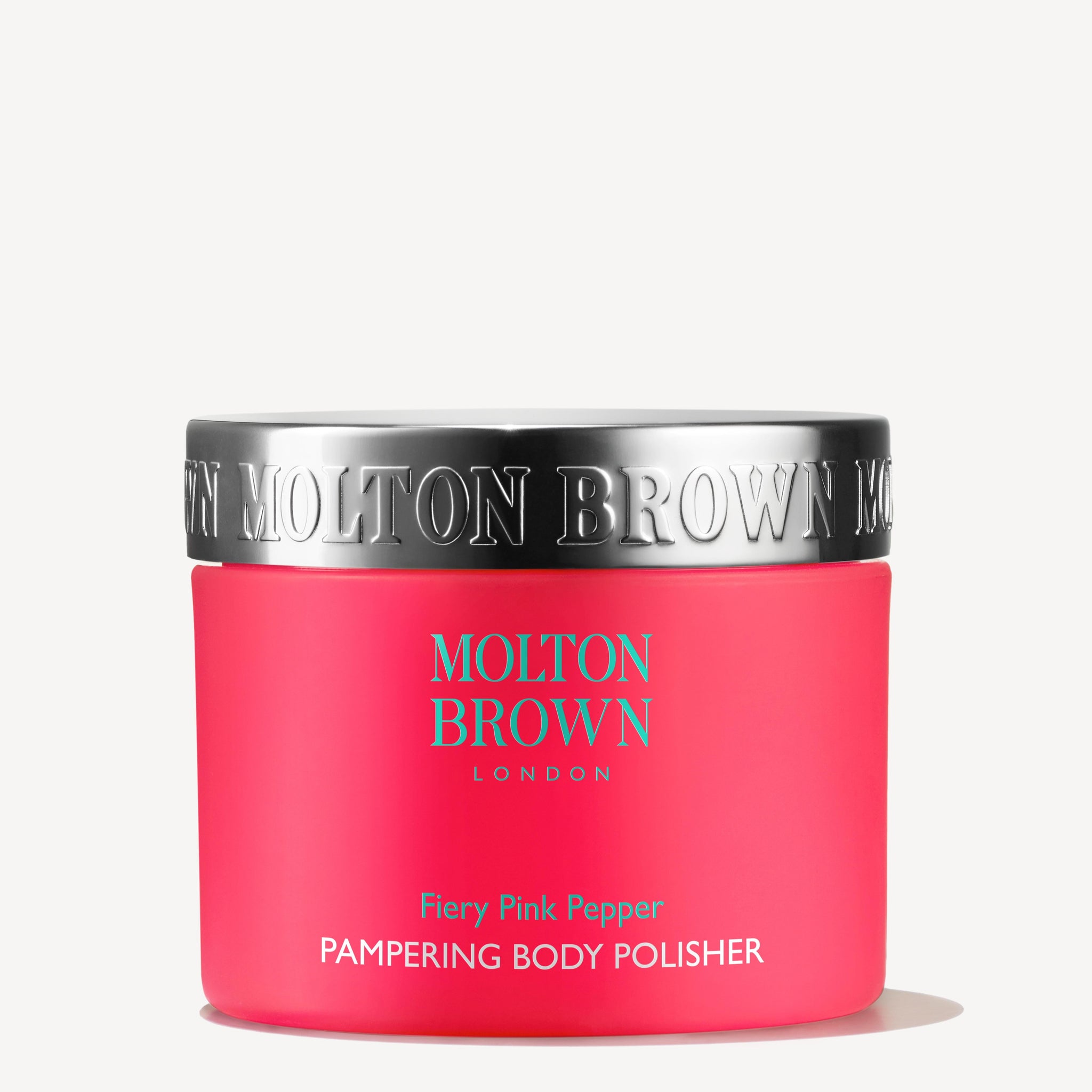 A vibrant pink container of MoltonBrown Cyprus Fiery Pink Pepper Pampering Body Polisher 275g comes with a shiny silver lid, embossed with the brand name on the side. The product details are elegantly printed in white on the front, and this body scrub is formulated with exfoliating bamboo to beautifully enhance skin texture.