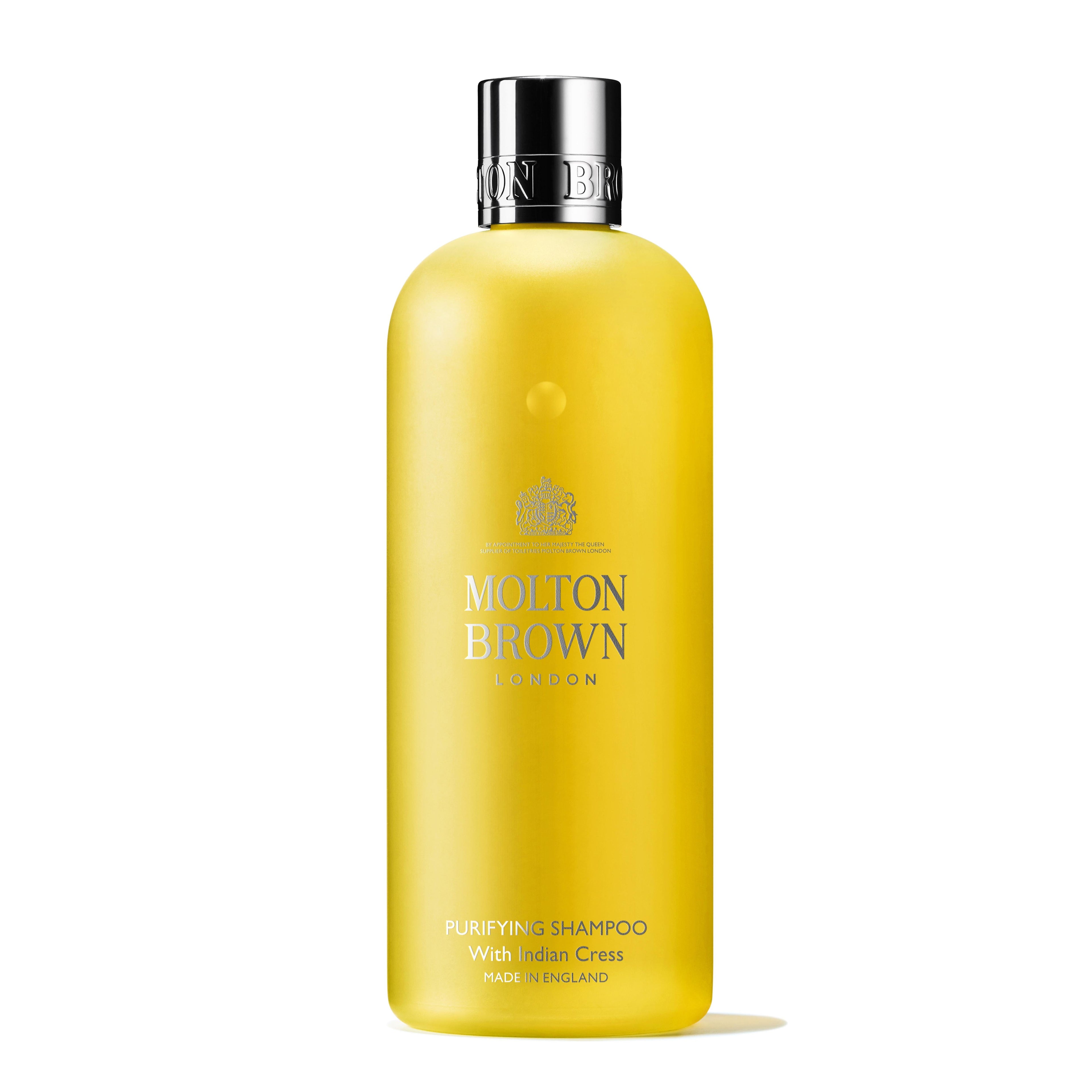 A yellow bottle of Purifying Shampoo With Indian Cress 300ml by MoltonBrown Cyprus, featuring a silver cap and white label text. The bottle stands elegantly against a plain white background, exuding a sense of purity and freshness.