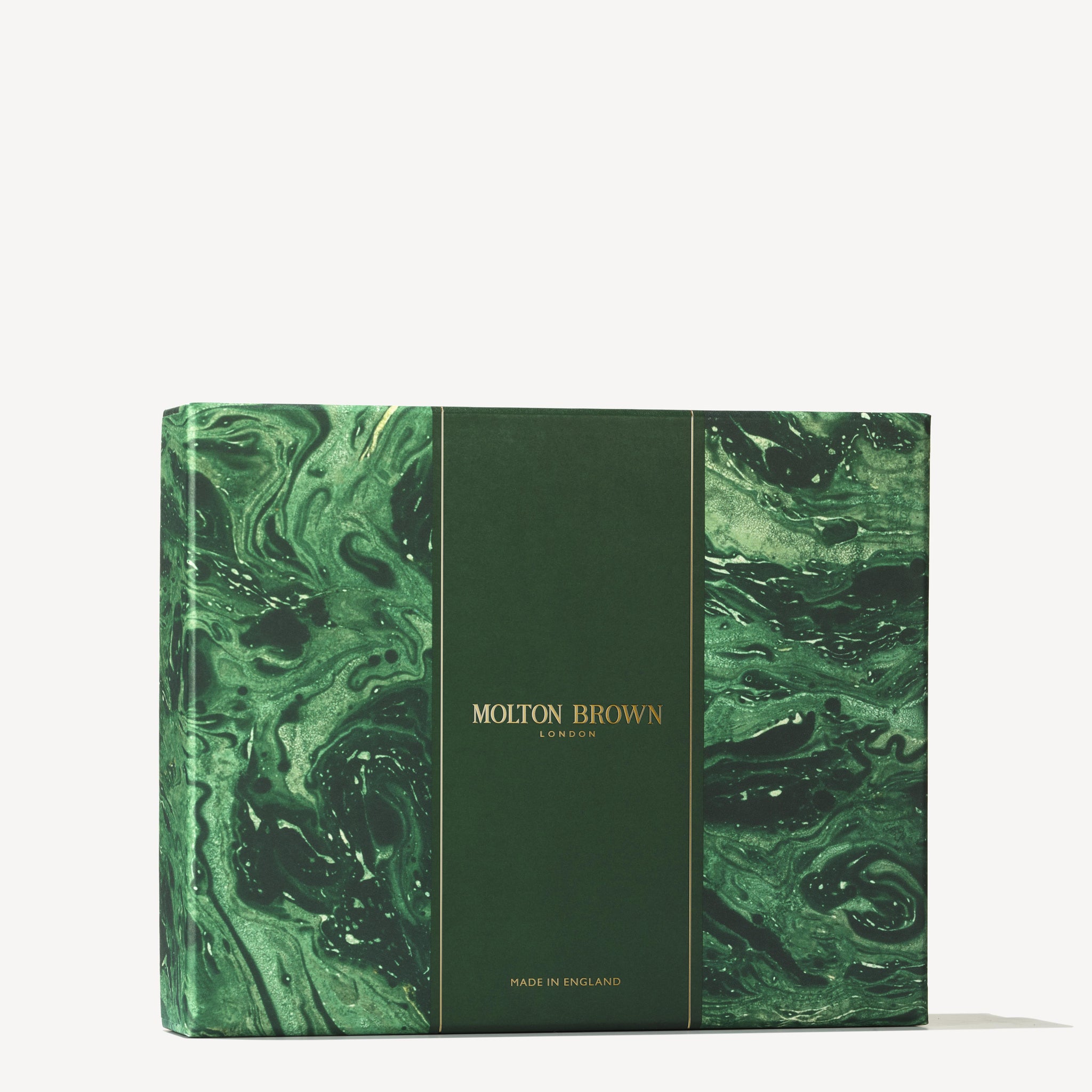 A marbled green box infused with marine notes showcases the brand name MoltonBrown Cyprus in gold on its center panel. At the bottom, "Made in England" is inscribed, with the swirling design reflecting Coastal Cypress hues combined with a touch of Eau de Toilette sophistication.