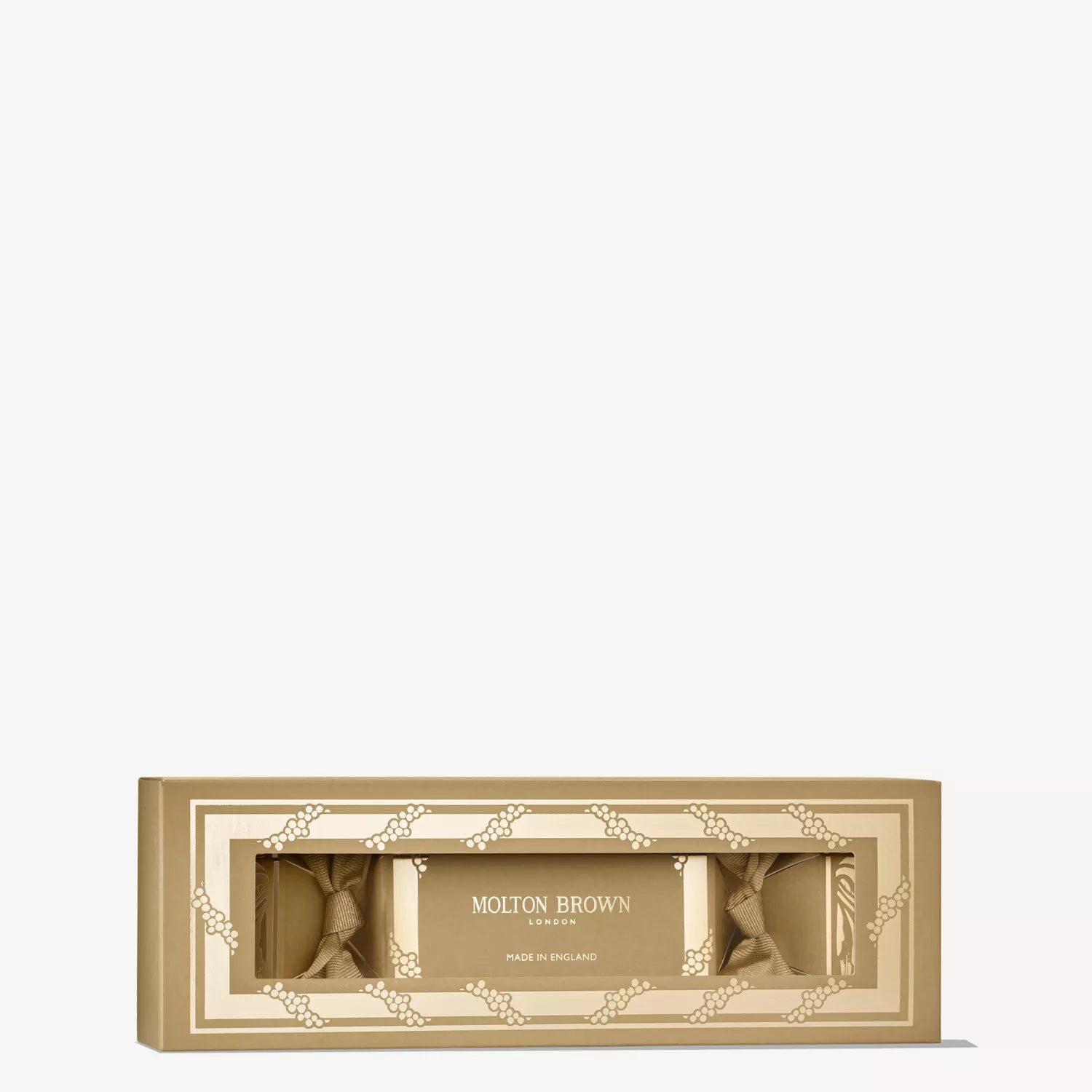 The MoltonBrown Cyprus Coastal Cypress & Sea Fennel Christmas Cracker features a gold rectangular gift box with a clear window showcasing three products, including a shower gel—an elegant, festive treat perfect for gifting.