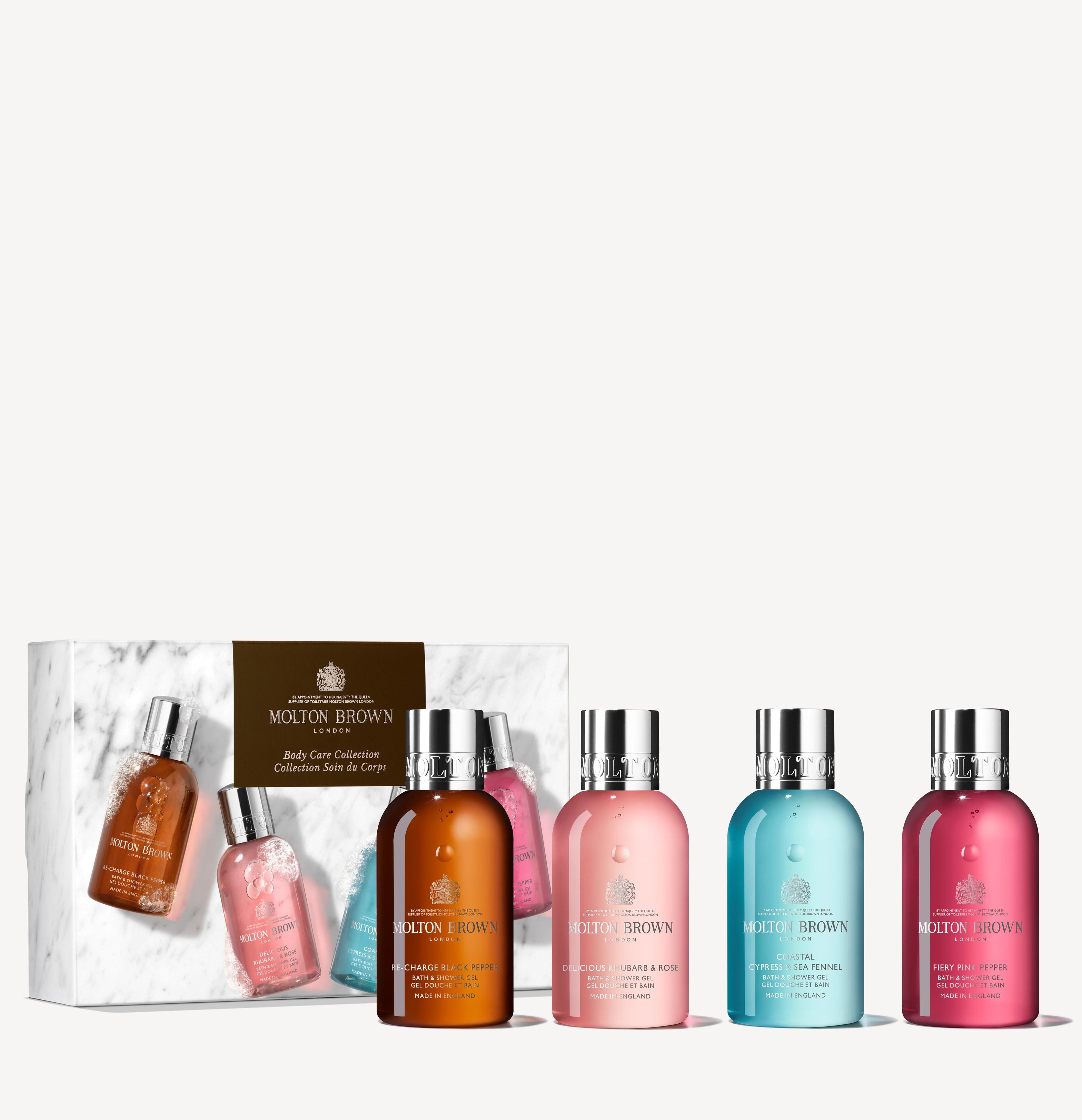 A set of MoltonBrown Cyprus Woody & Floral Body Care Collection, showcasing five unique fragrances in an array of colors, elegantly arranged in front of a partially opened white and brown gift box. Ideal for enhancing your travel bathing experience.