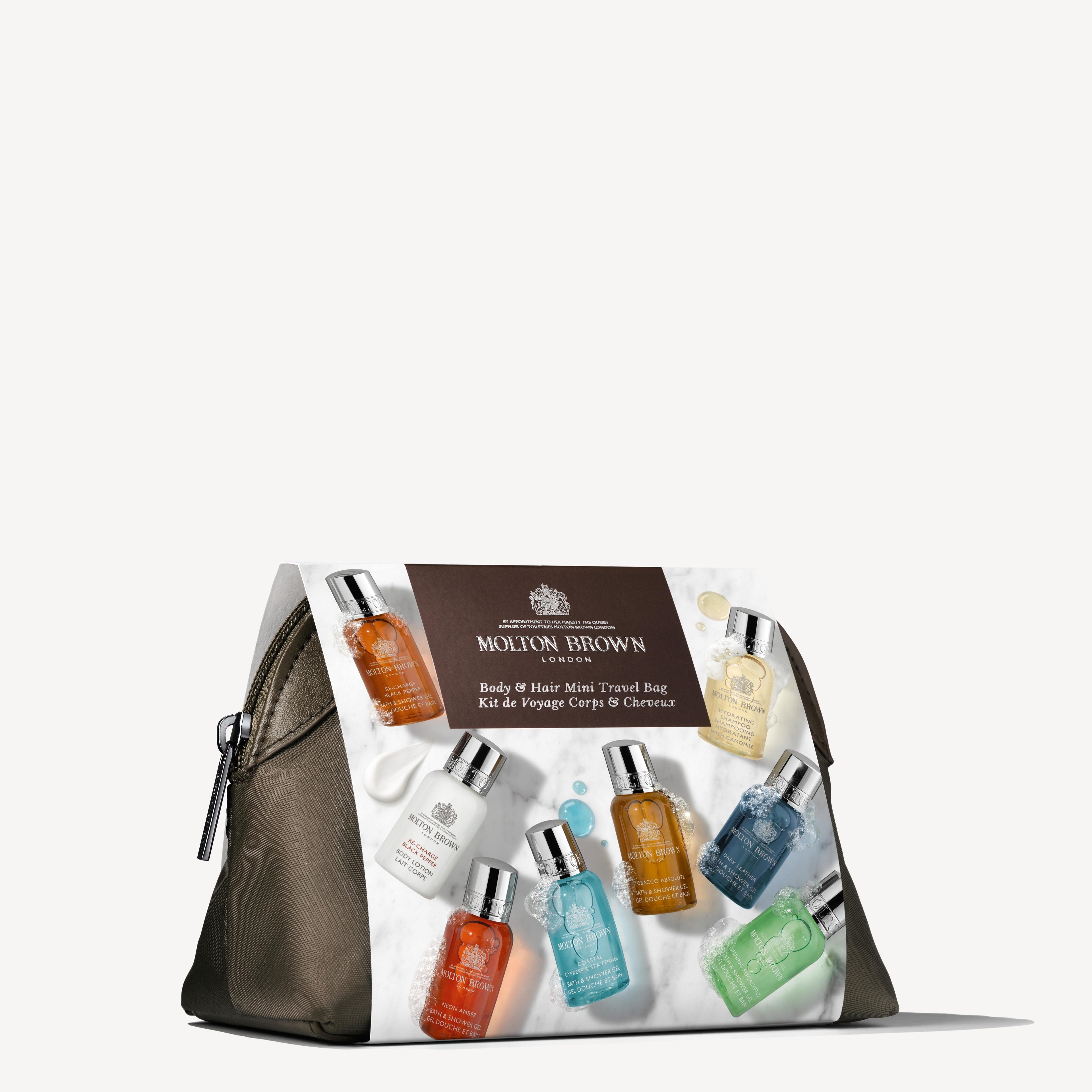 An olive green "The Classic Explorer Body & Hair Mini Travel Bag" from MoltonBrown Cyprus, featuring elegant silver zipper details and the brand's logo along with product information on the front. It contains a selection of colorful Bath, Body, and Hair Care miniatures—an ideal reusable travel companion to elevate your daily rituals.