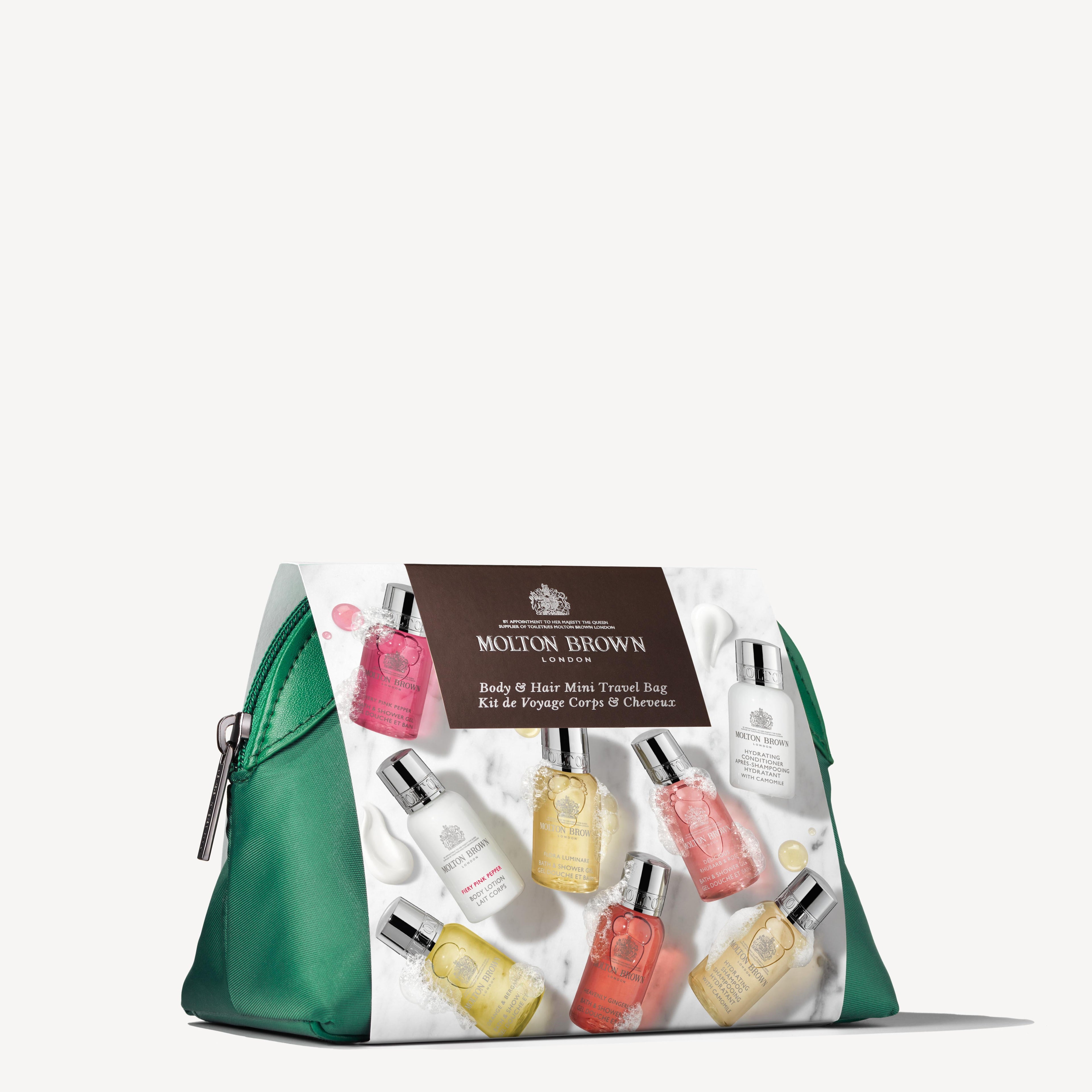 The Elegant Escapist Body & Hair Mini Travel Bag, featuring the MoltonBrown Cyprus label, is presented in a green zippered travel bag. It showcases eight mini bottles of bath and body care products in various colors, highlighting citrus fragrances arranged around the central brand label on a white background.