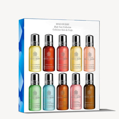 A boxed set of 12 MoltonBrown Cyprus Bath & Shower Gels, each showcasing a unique fragrance and vibrant color, adorned with the brand's logo. The "Discovery Body Care Collection" box is elegantly designed with a charming heart motif on the side.