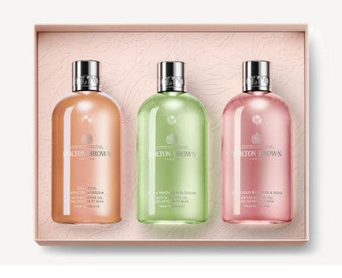 Explore the Floral & Fruity Body Care Gift Set from MoltonBrown Cyprus, featuring three floral-fruity Bath & Shower Gel bottles. These elegant peach, green, and pink bottles with silver caps capture the spirit of an English garden. They come beautifully arranged in a rectangular box with a textured insert for a touch of botanical bliss.