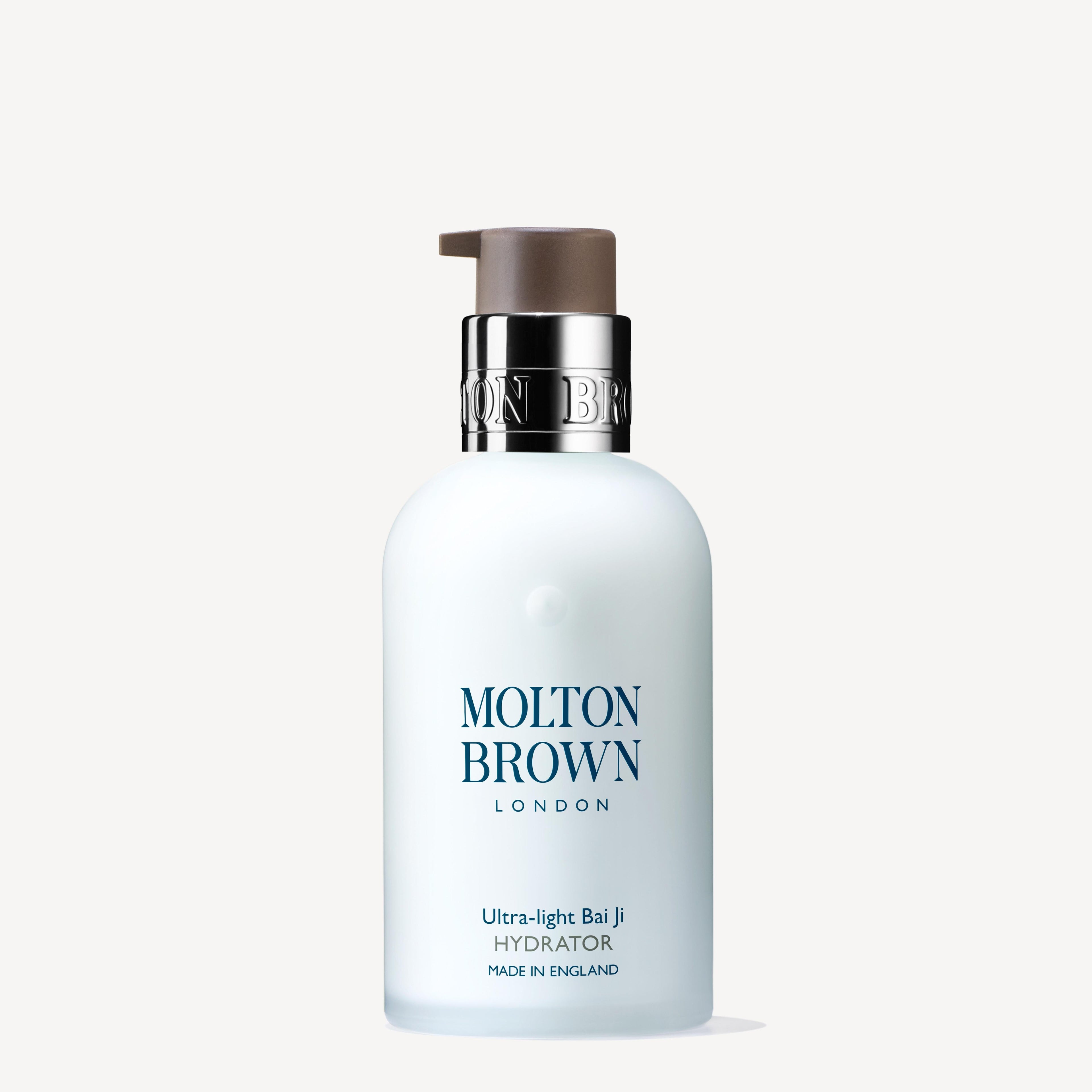 A 100ml bottle of Ultra-light Bai Ji Hydrator by MoltonBrown Cyprus, featuring a pump dispenser. This lightweight moisturizer is enriched with lentil seed extracts, and the design includes a white bottle adorned with dark blue text showcasing the brand name and product details.