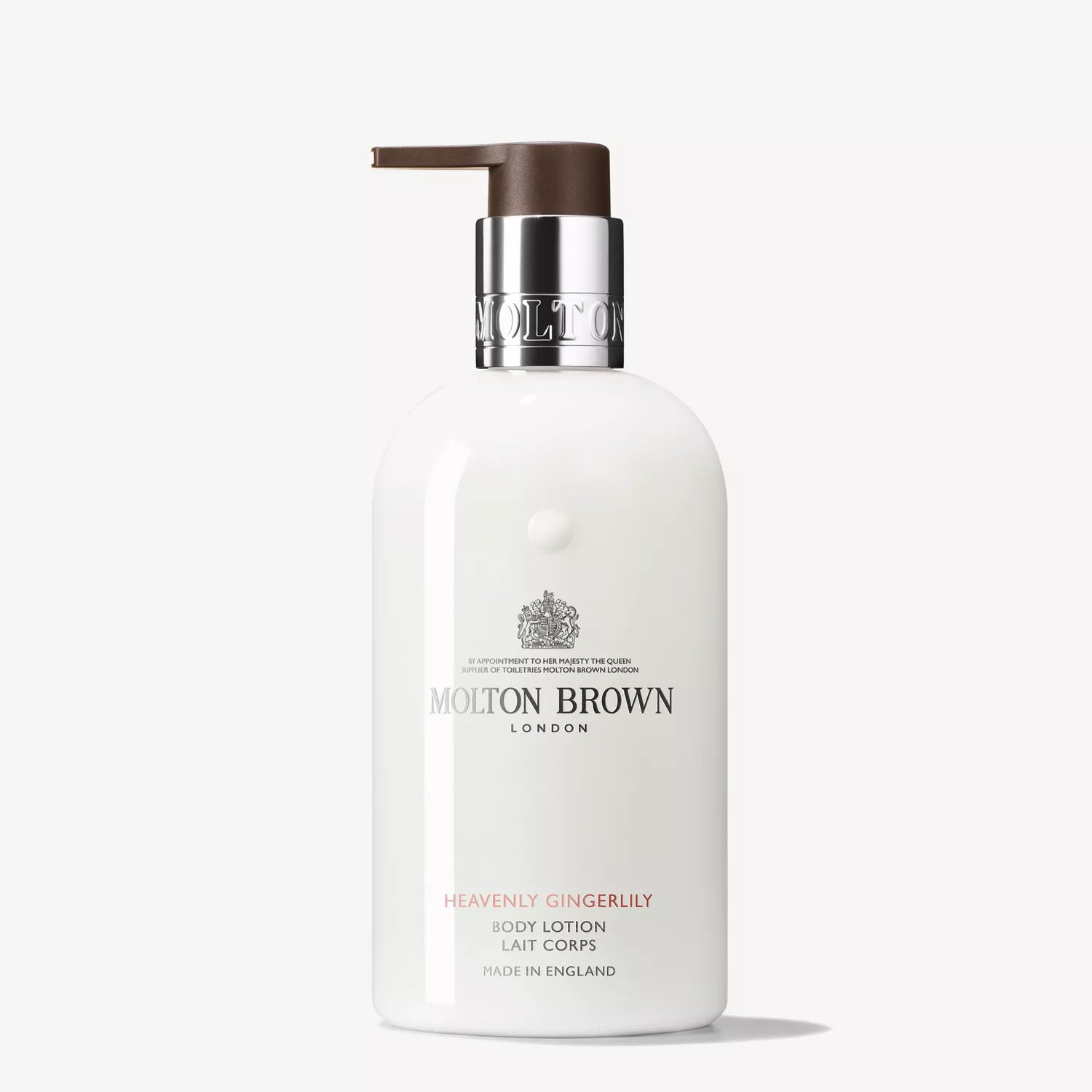 A Molton Brown Cyprus Heavenly Gingerlily Body Lotion 300ml bottle with a brown pump features a label with the brands logo and product details in gray and red, promising to moisturize your skin and leave an alluring scent.