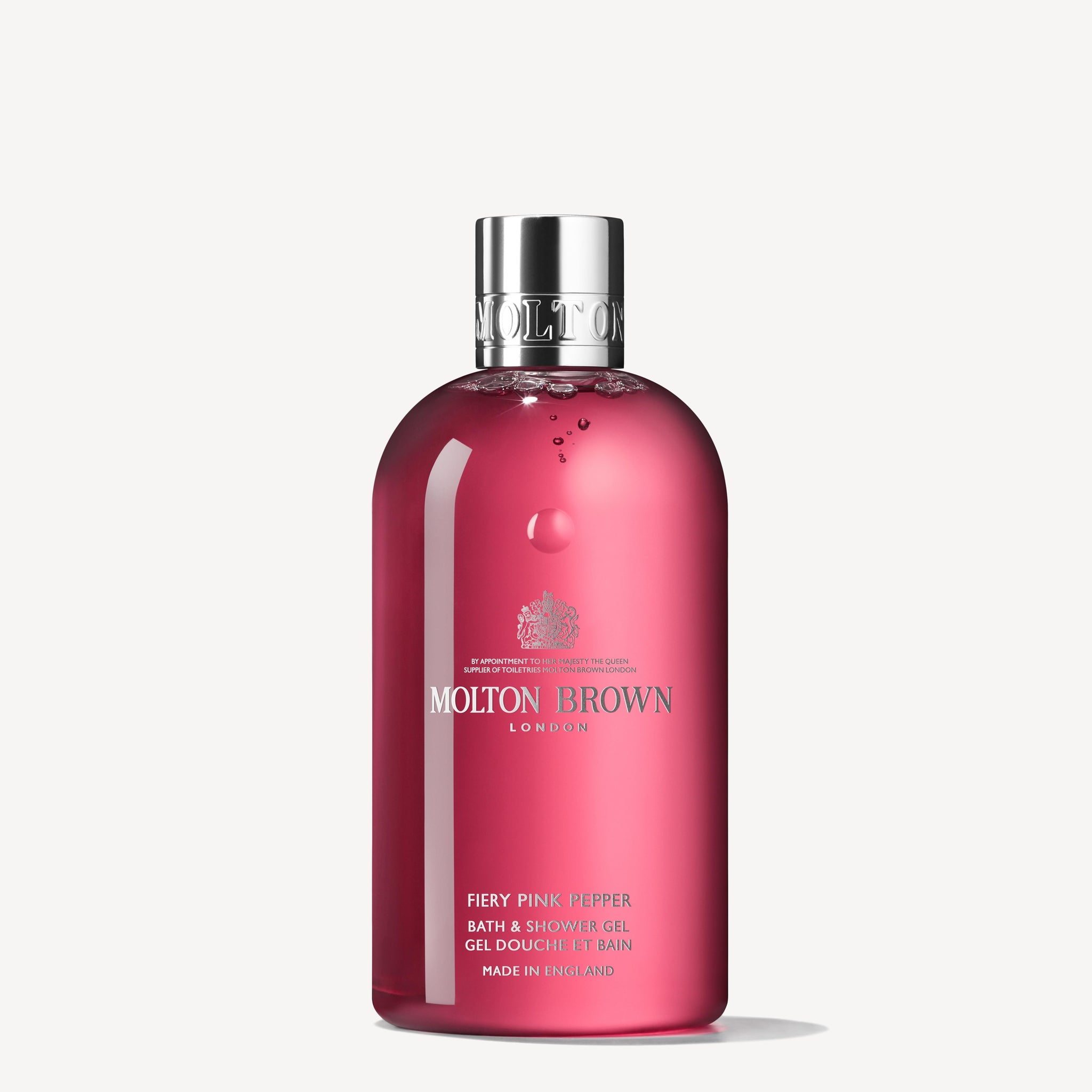 The Fiery Pink Pepper Bath & Shower Gel 300ml by MoltonBrown Cyprus is an invigorating body wash. It comes in a transparent red bottle that highlights notes of pink pepper and patchouli, with the brand name displayed in white text, topped off with a silver cap against a plain white background.