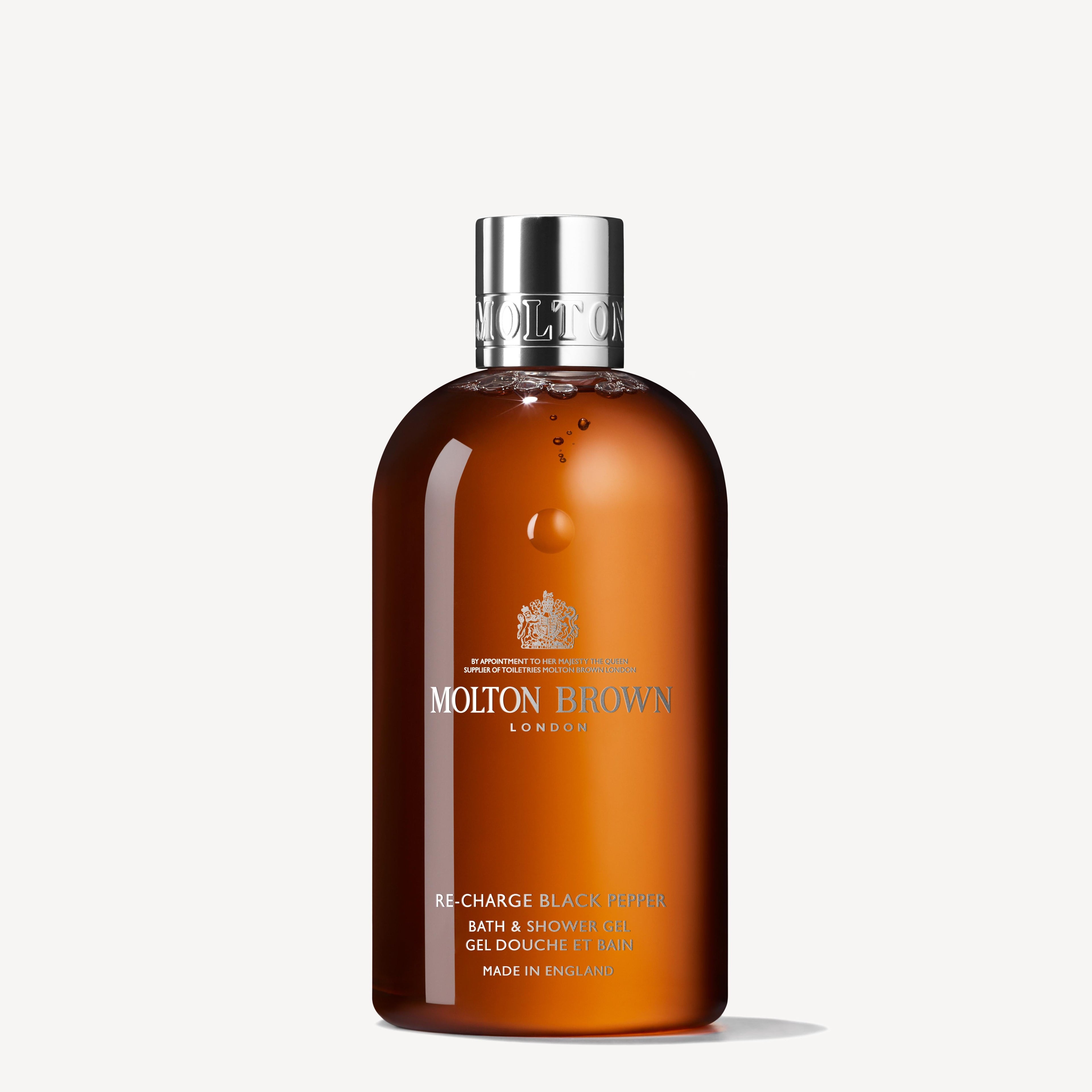 The Re-charge Black Pepper Bath & Shower Gel 300ml by MoltonBrown Cyprus is ideal for refreshing after an exhilarating off-road journey. This amber-colored packaging, featuring sleek silver text and a gleaming silver cap, stands out beautifully against a plain white background, adding a touch of sophistication to your daily routine.