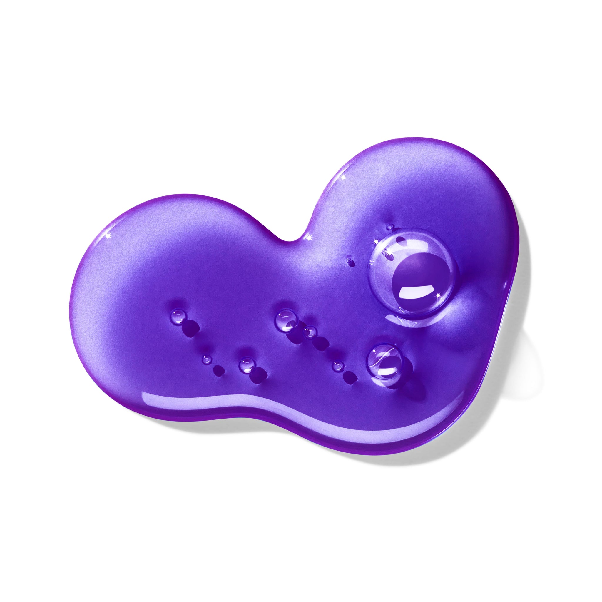 A glossy, irregularly shaped blob of MoltonBrown Cyprus's Relaxing Ylang-Ylang Bath & Shower Gel is displayed on a white background. This vibrant purple gel, infused with ylang-ylang, features several small raised bubbles and a larger bubble on its reflective surface.