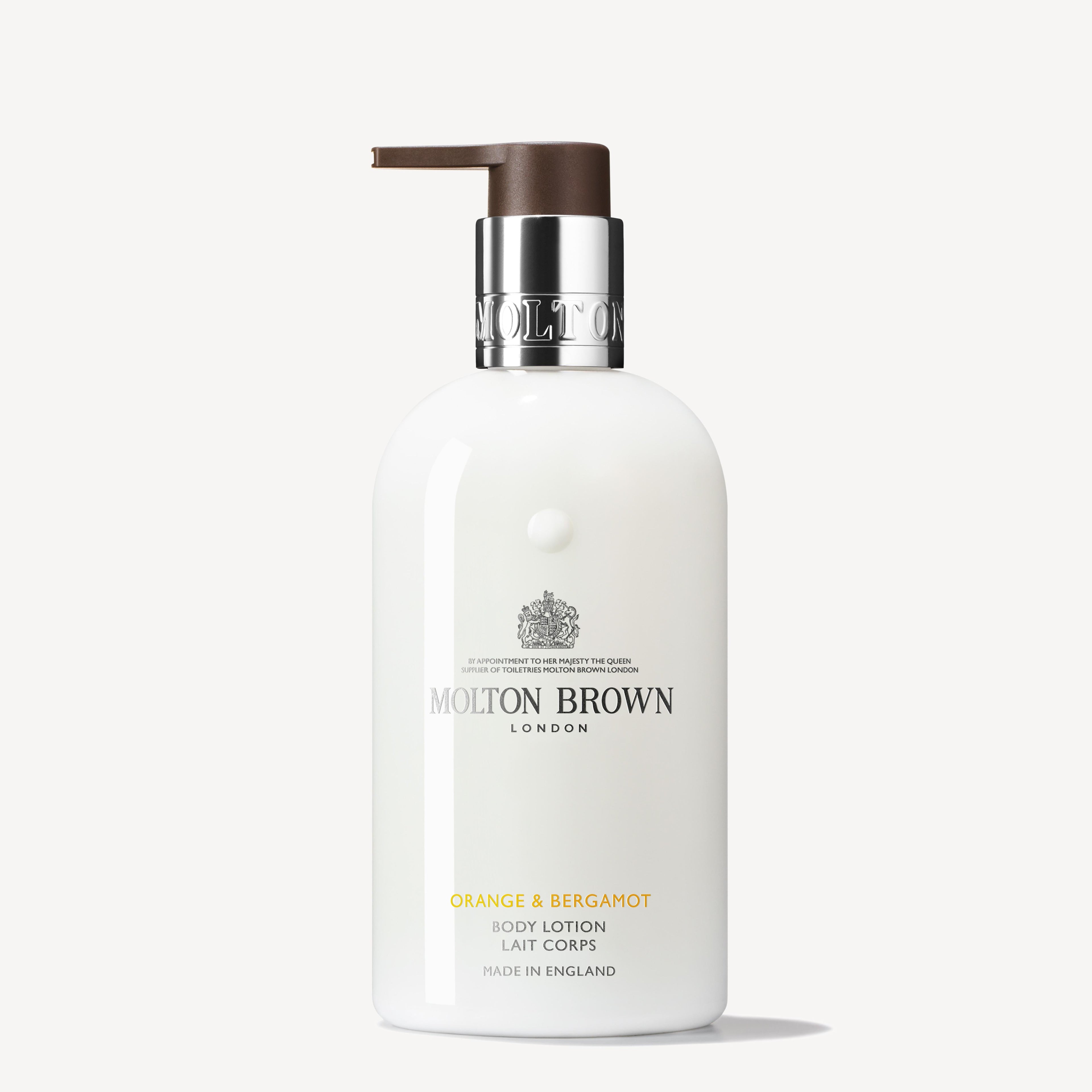 A white bottle of MoltonBrown Cyprus Orange & Bergamot Body Lotion 300ml with a pump dispenser. The label features the product name and branding details in silver and gold, suggesting hints of sparkling mandarin and neroli notes. The bottle is positioned against a simple, off-white background.