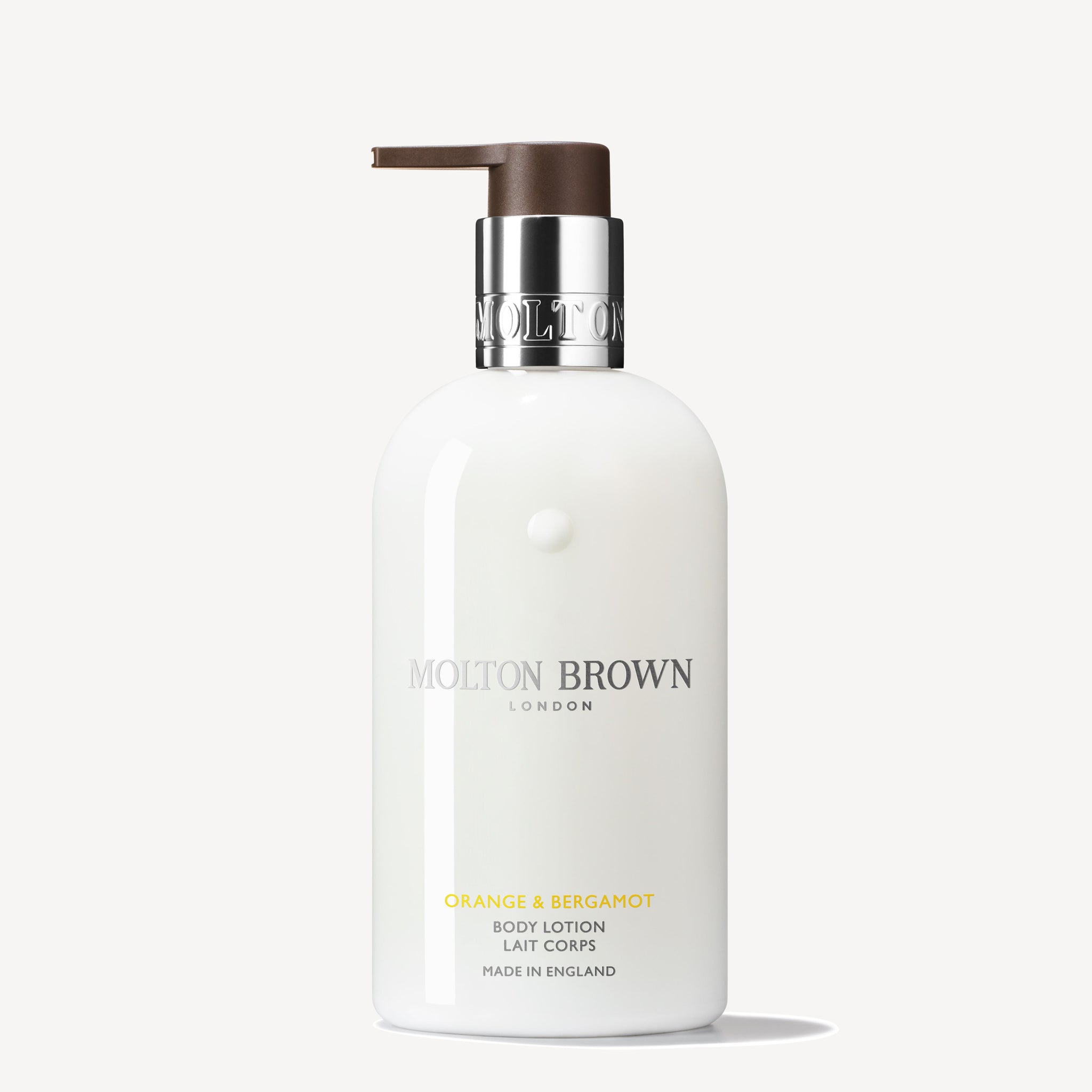 A white bottle of MoltonBrown Cyprus Orange & Bergamot Body Lotion 300ml with a pump dispenser. The label features the product name and branding details in silver and gold, suggesting hints of sparkling mandarin and neroli notes. The bottle is positioned against a simple, off-white background.