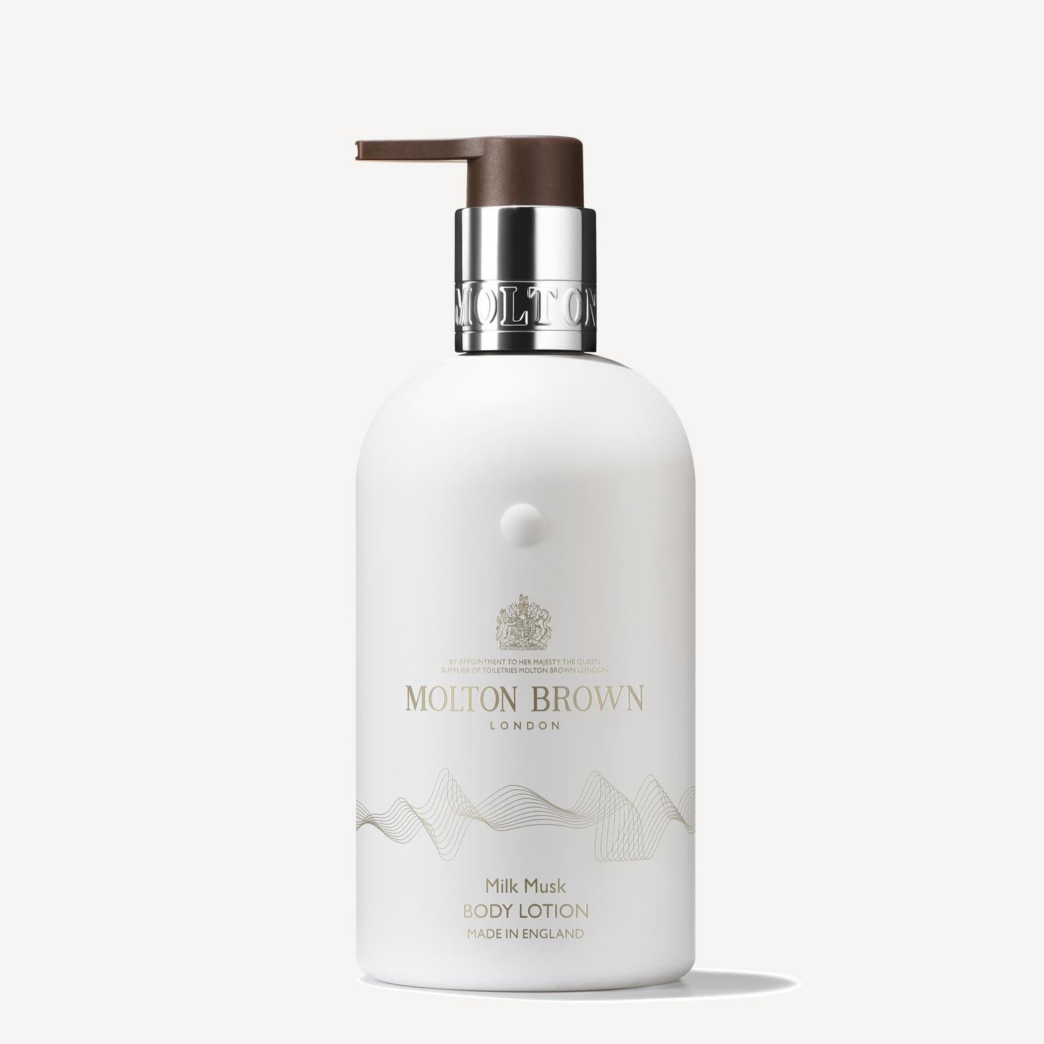 The Milk Musk Body Lotion 300ml from MoltonBrown Cyprus features soothing milk and creamy musk in a sleek white bottle with a pump dispenser and silver accents. The elegant font on the label highlights the brand name and product details, adding a touch of luxury.