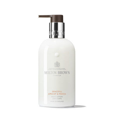 A 300ml bottle of MoltonBrown Cyprus Graceful Apricot & Freesia Body Lotion with a pump dispenser. The white packaging, adorned with silver accents and text, gracefully highlights the apricot and freesia blend.