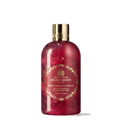 Introducing the MoltonBrown Cyprus Merry Berries & Mimosa Bath & Shower Gel, ideal for a seasonal bathing experience. This floral-fruity body wash features a red liquid and a golden cap, adorned with festive patterns and detailed brand information on the label.