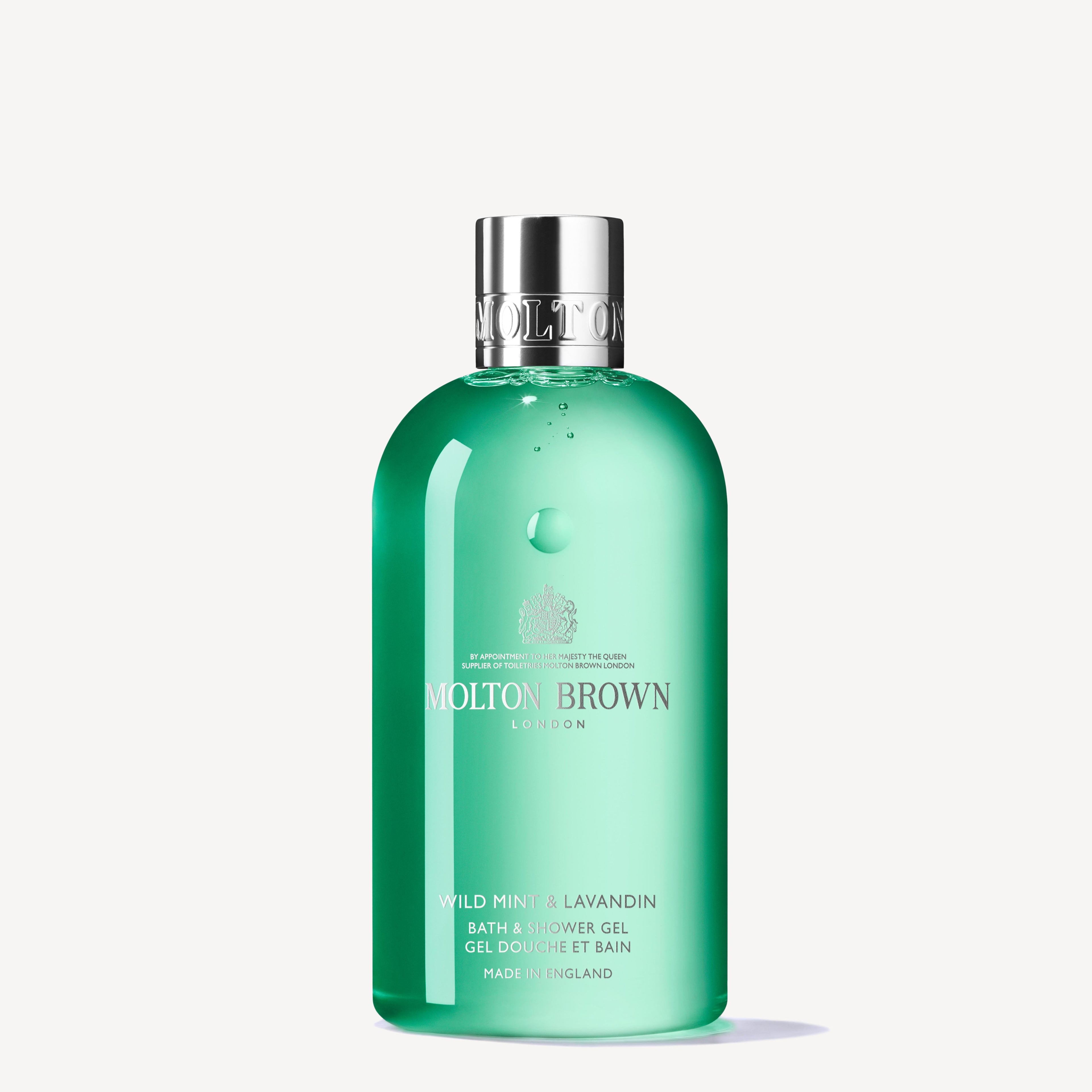 A 300ml bottle of MoltonBrown Cyprus Wild Mint & Lavandin Bath & Shower Gel features an infusion of wild mint, lavandin, and orris root. The gel is green, topped with a silver cap, and showcases elegantly printed product details on the front.