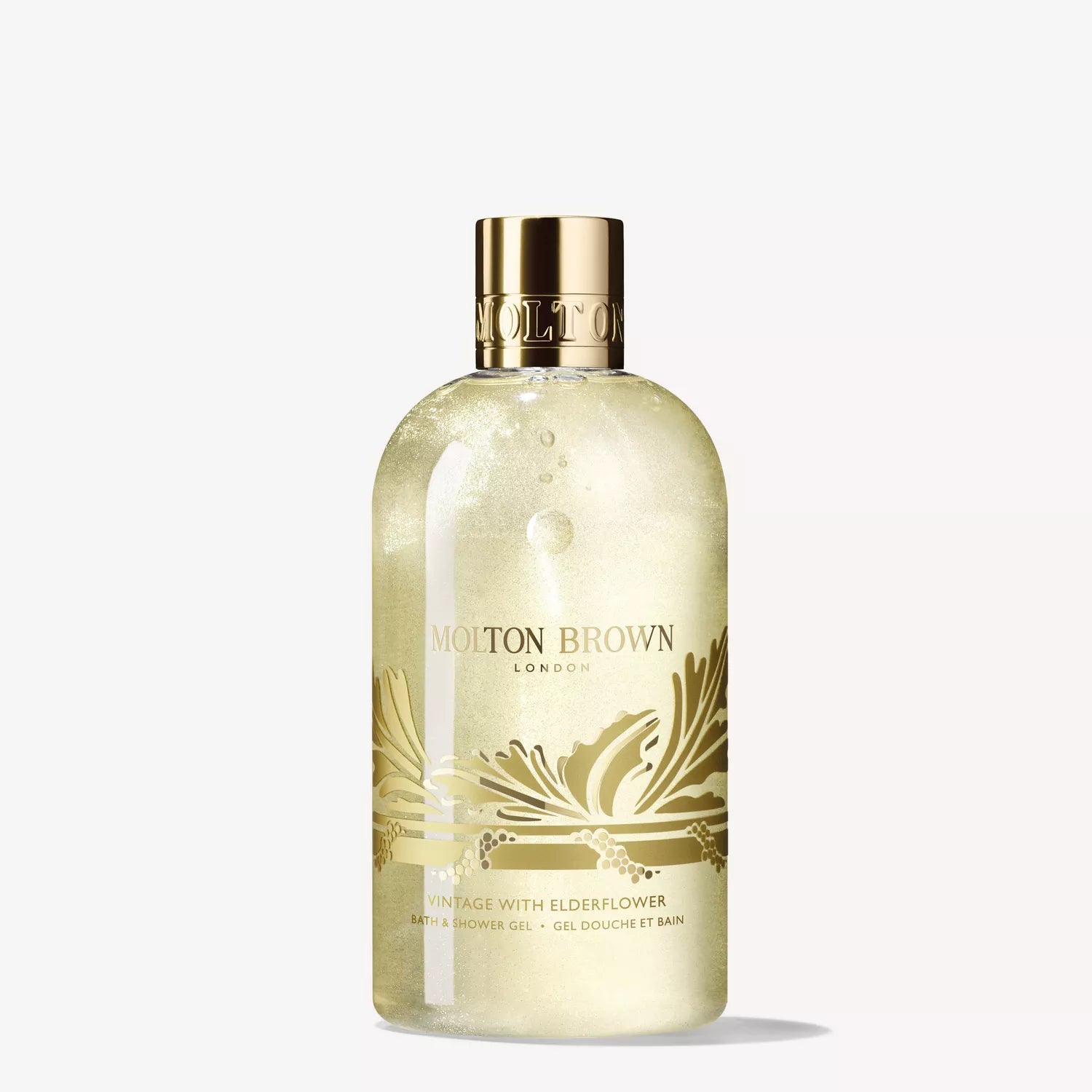 A clear 300ml bottle of MoltonBrown Cyprus Vintage With Elderflower Bath & Shower Gel, featuring gold accents, a gold cap, botanical design, and a fresh floral-fruity fragrance.