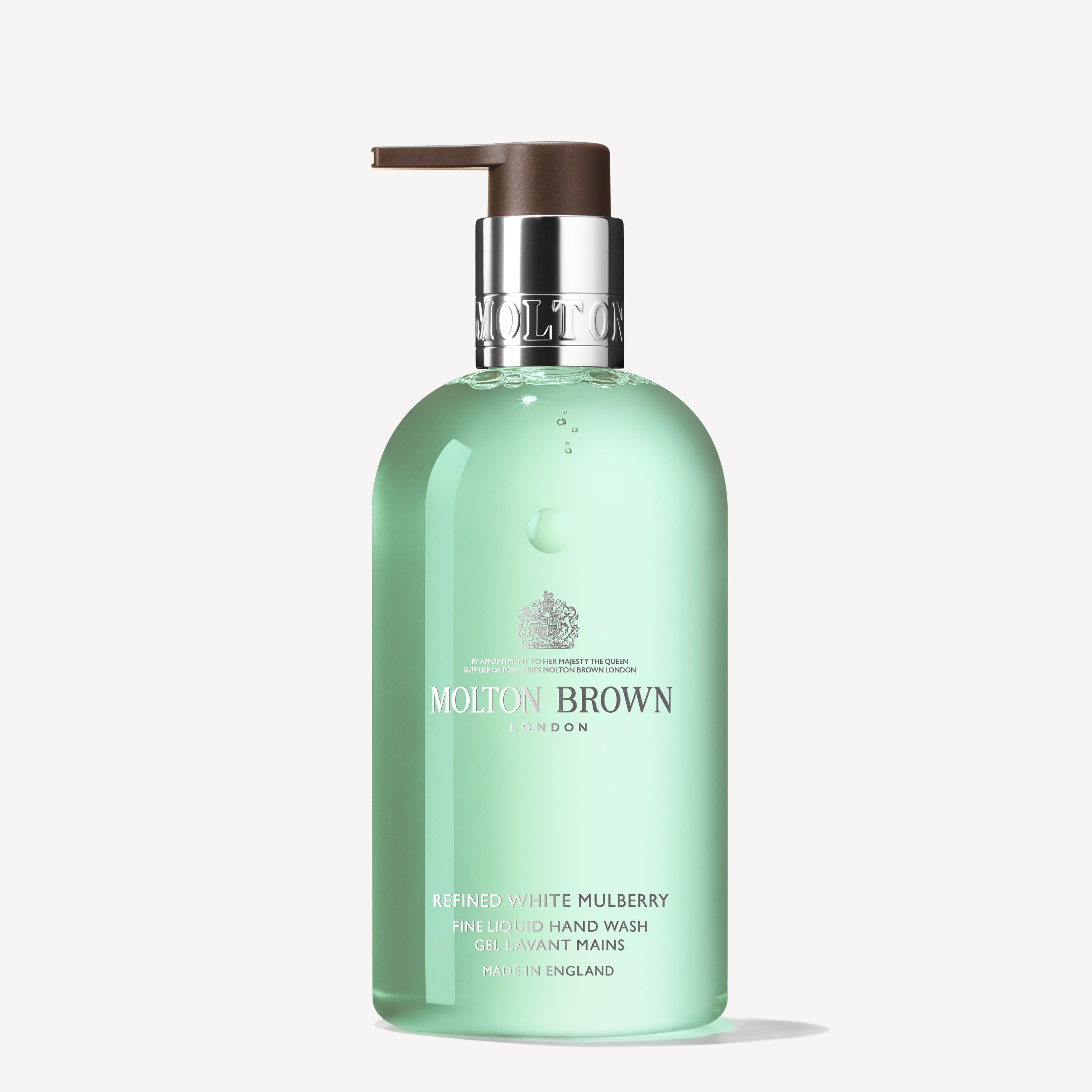 A bottle of MoltonBrown Cyprus Refined White Mulberry Fine Liquid Hand Wash 300ml with a pump dispenser features a translucent green design, elegantly accented with white text for branding and product information.