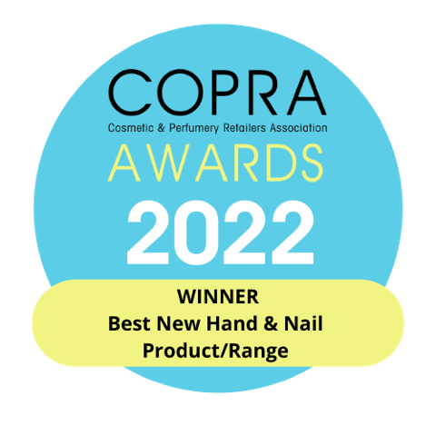 Blue circular badge with COPRA Cosmetic & Perfumery Retailers Association AWARDS 2022 text. Yellow banner at the bottom reads WINNER Best New Hand & Nail Product/Range, featuring Flora Luminare Fine Liquid Hand Wash by MoltonBrown Cyprus, infused with luxurious hints of vanilla and orange blossom.