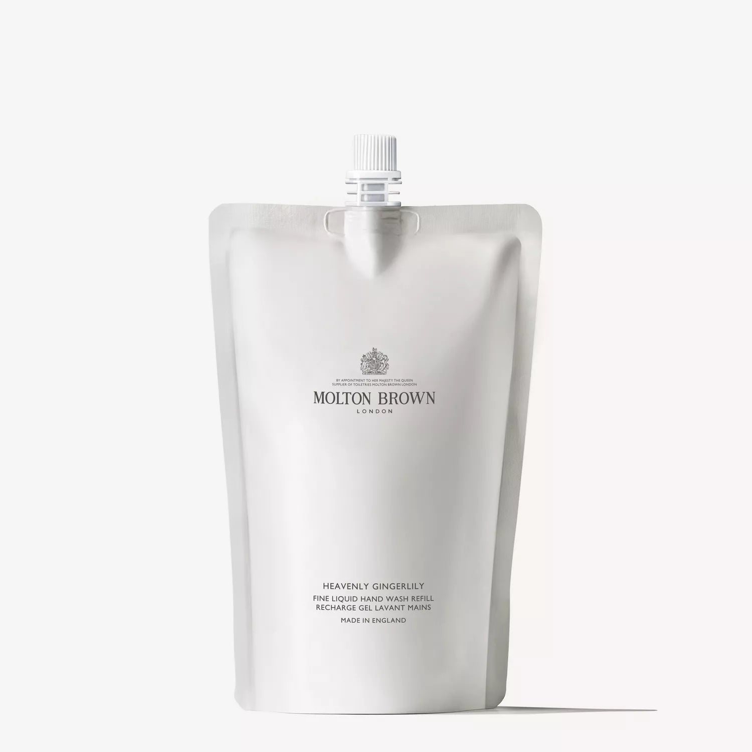 A silver pouch labeled Molton Brown Cyprus with a spout features the text Heavenly Gingerlily Fine Liquid Hand Wash Refill. It offers the warm scent of ginger, contains 400ml, and is made in England.