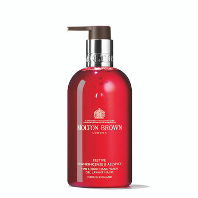 A bottle of MoltonBrown Cyprus's Festive Frankincense & Allspice Fine Liquid Hand Wash, featuring a pump dispenser and a red color, is set against a plain white background. It offers an enticing spiced frankincense aroma with subtle woody notes.