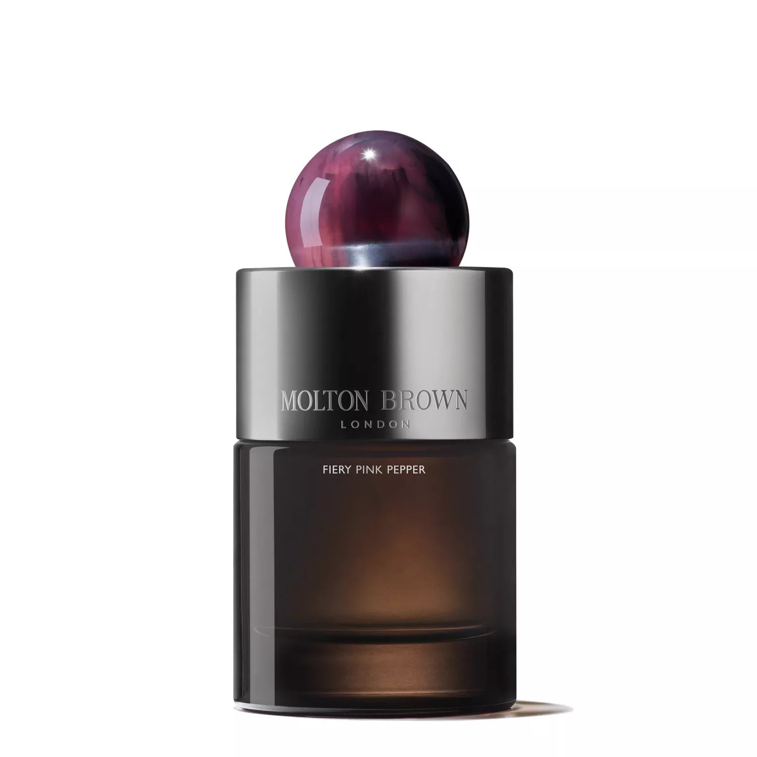 MoltonBrown Cyprus offers the Fiery Pink Pepper Eau de Parfum 100ml in a sleek, dark cylindrical bottle with a glossy marbled cap, with its label highlighting Molton Brown London and Fiery Pink Pepper, featuring a spicy pink pepper heart balanced by rich patchouli notes.