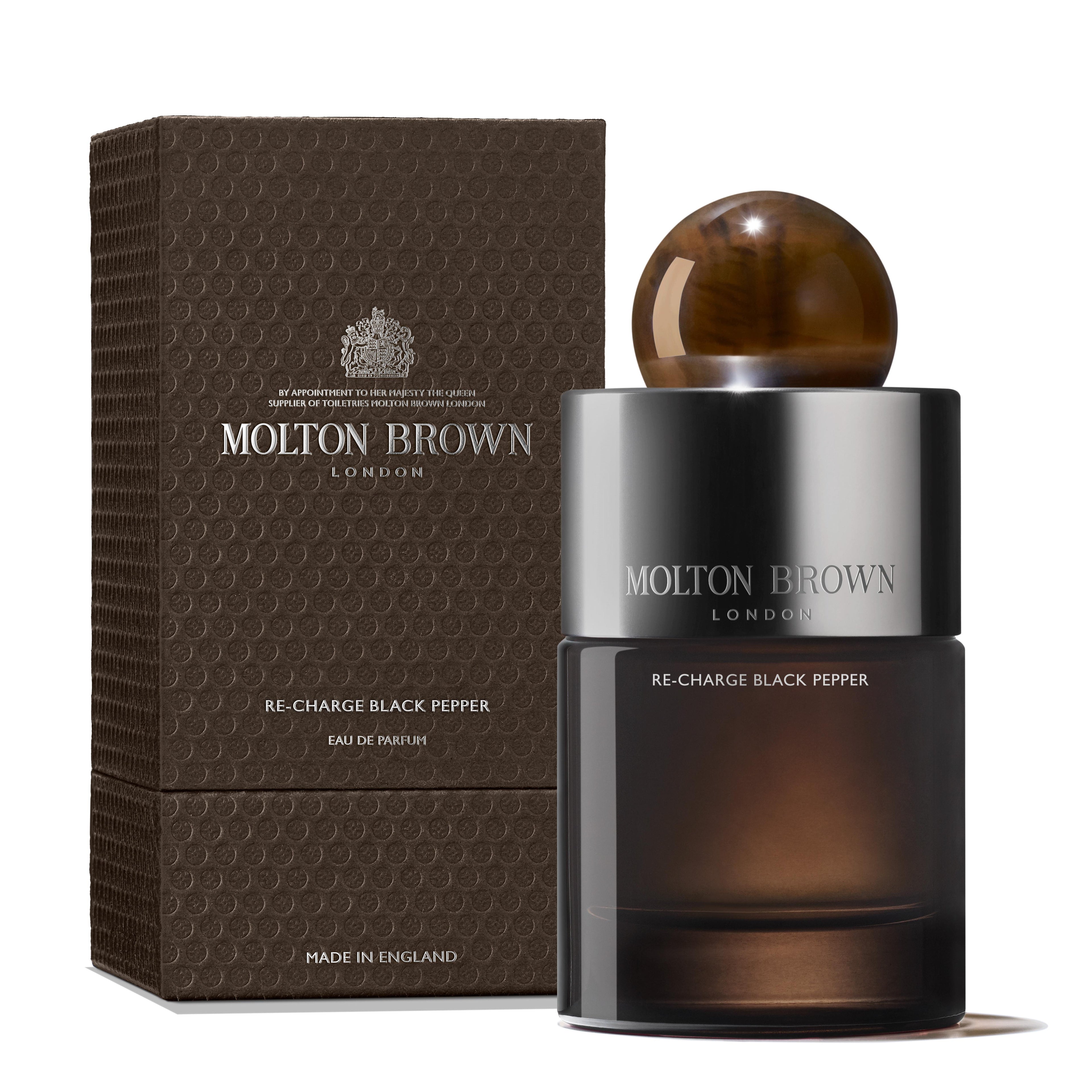 A MoltonBrown Cyprus Re-charge Black Pepper Eau de Parfum 100ml bottle paired with its textured brown box. The elegant design, featuring a spherical cap, suggests hints of invigorating bergamot, with the brand's name prominently displayed on both the box and bottle.