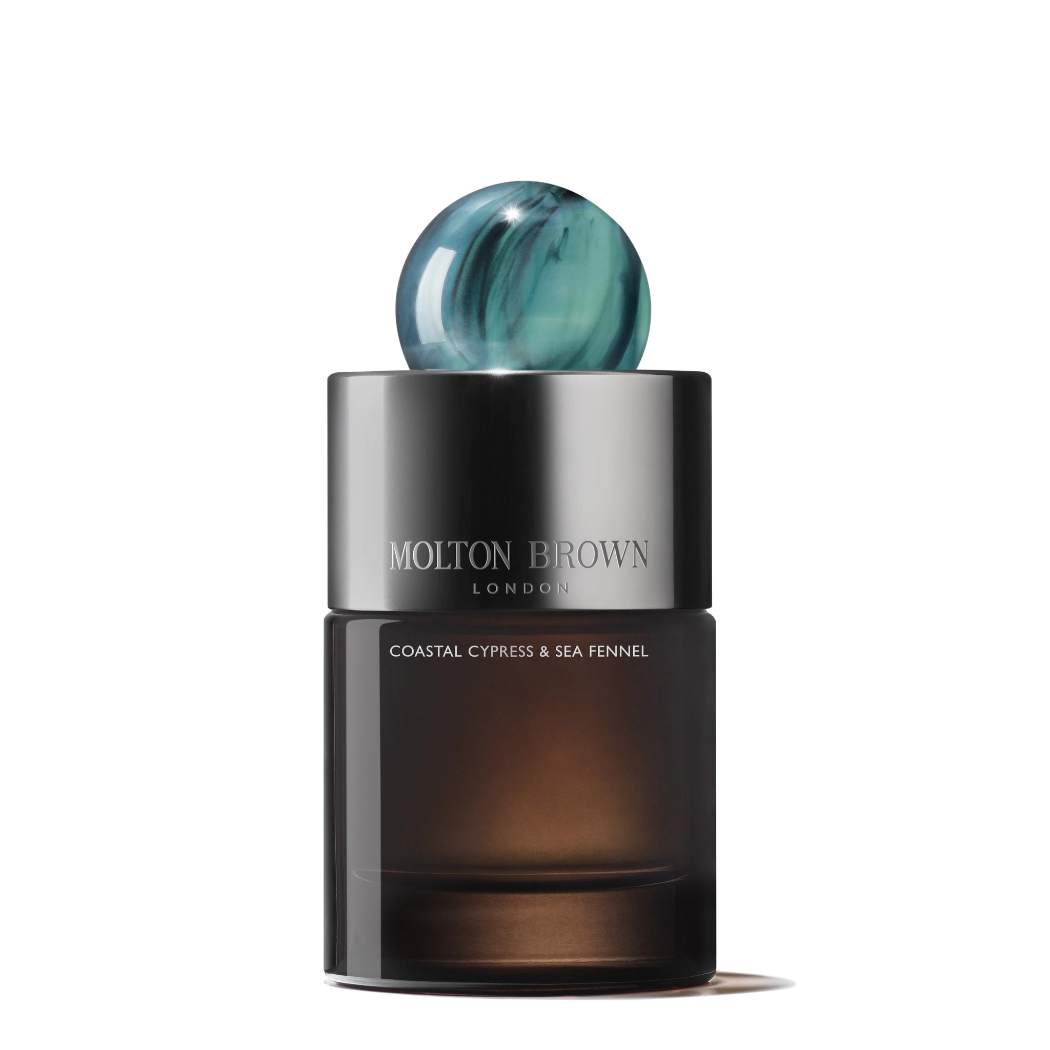 The Coastal Cypress & Sea Fennel Eau de Parfum 100ml by MoltonBrown Cyprus is housed in a sophisticated, dark brown bottle with a gleaming silver cap and adorned with a blue, marbled decorative sphere. This ocean-inspired fragrance embodies coastal serenity and elegance.