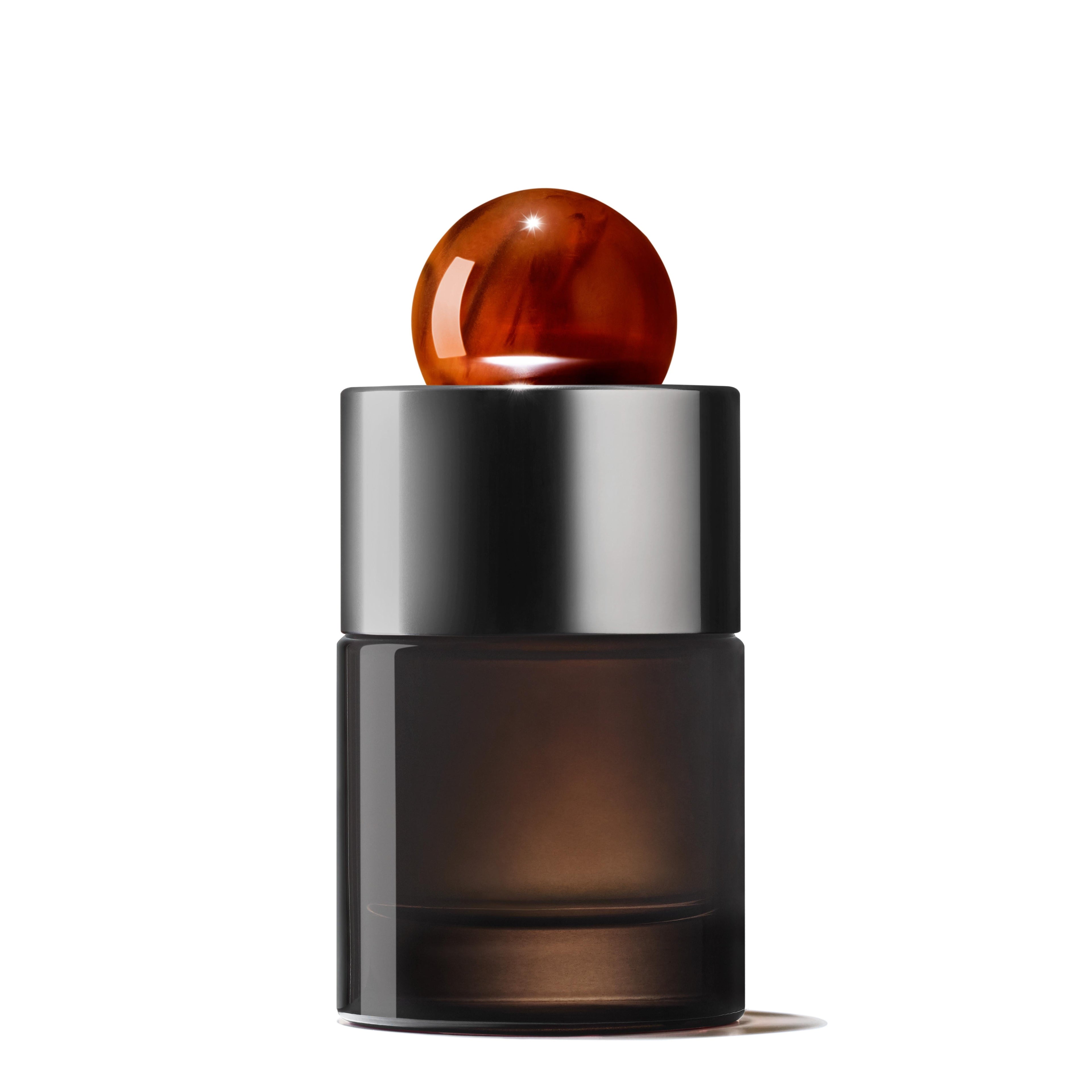 A sleek, dark glass bottle of Neon Amber Eau de Parfum by MoltonBrown Cyprus, featuring a reflective silver cap and a glossy amber-colored spherical topper designed by Jérôme Di Marino, is elegantly positioned against a plain white background.