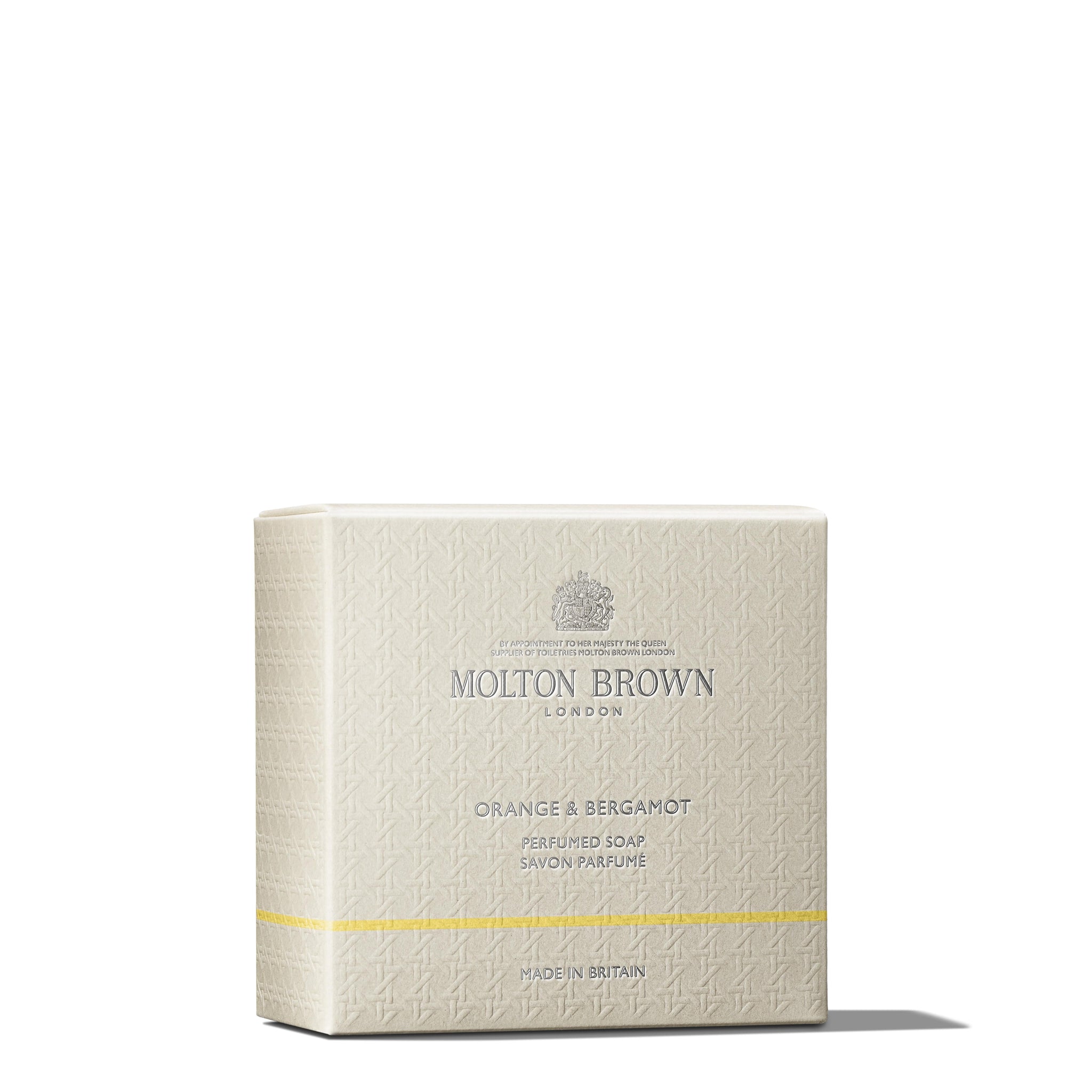 A boxed MoltonBrown Cyprus Orange & Bergamot Perfumed Soap, offering a refreshing citrus fragrance. The light beige packaging features subtle embossed designs, with the brand logo centered at the top and the product name in the middle, accented by a small yellow band near the bottom.