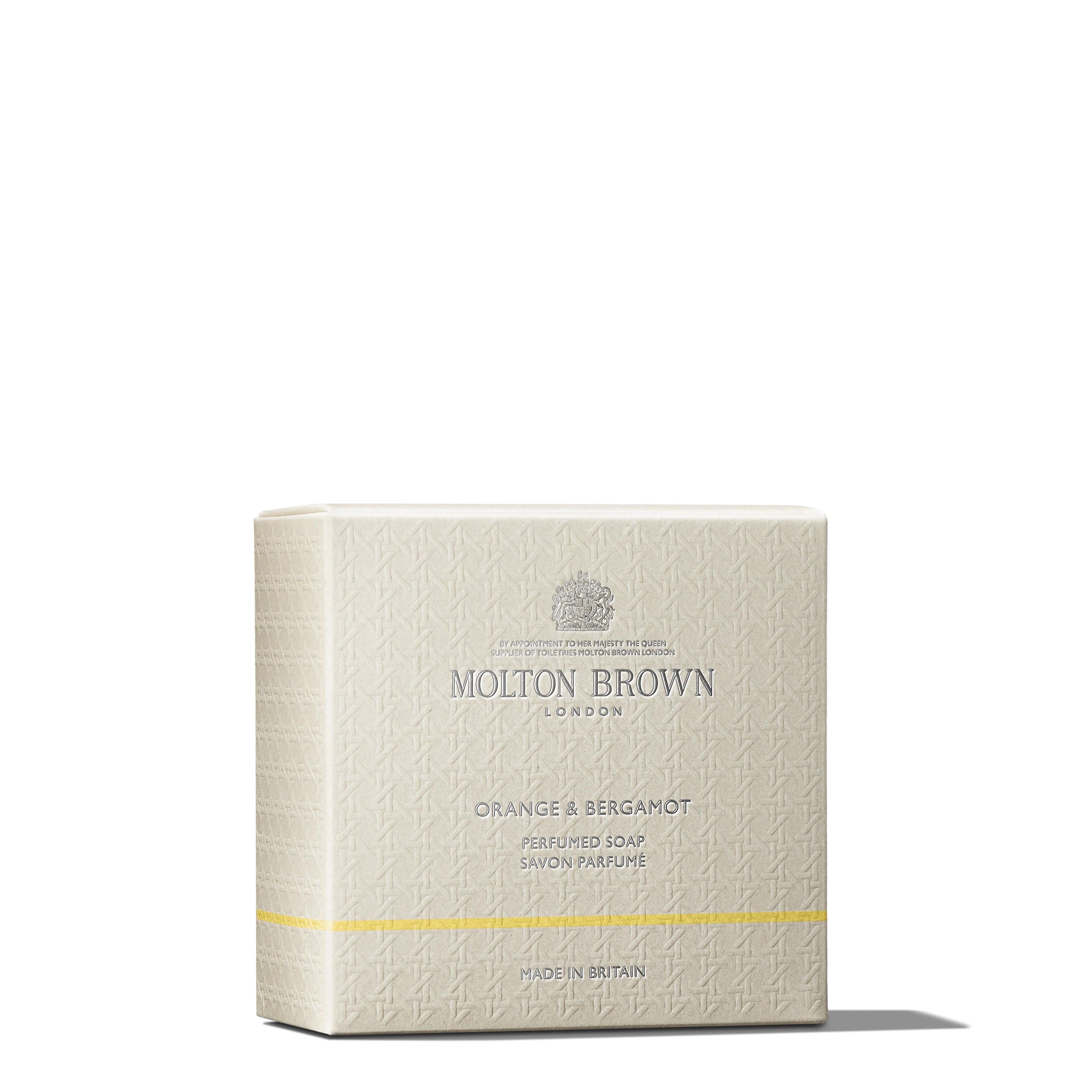 A boxed MoltonBrown Cyprus Orange & Bergamot Perfumed Soap, offering a refreshing citrus fragrance. The light beige packaging features subtle embossed designs, with the brand logo centered at the top and the product name in the middle, accented by a small yellow band near the bottom.