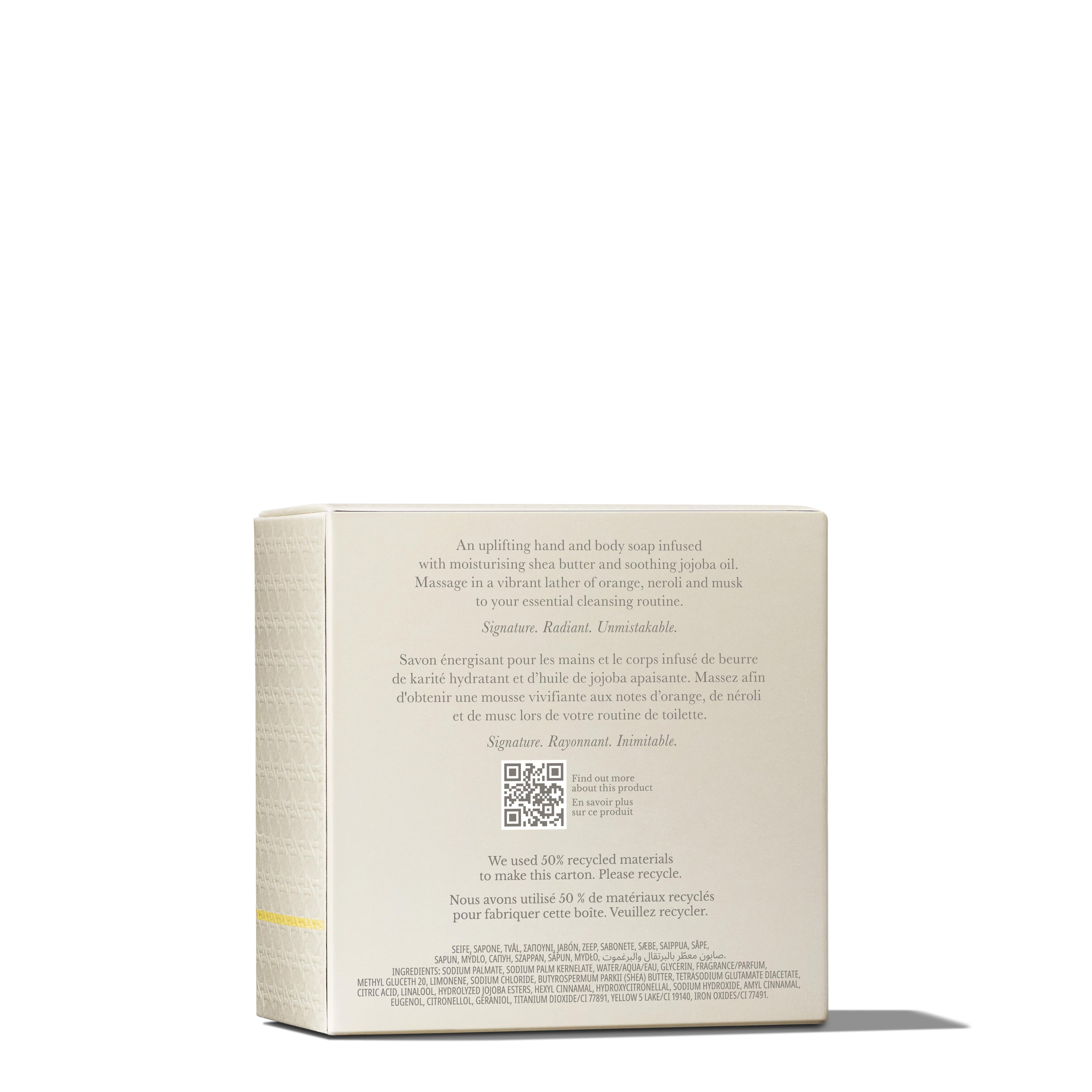 A rectangular soap box in a light cream color, displays text in both English and French, presenting the product as MoltonBrown Cyprus's Orange & Bergamot Perfumed Soap 150g, enriched with shea butter, jojoba oil, and a subtle citrus aroma. A QR code is centered below the text on the back of the box.