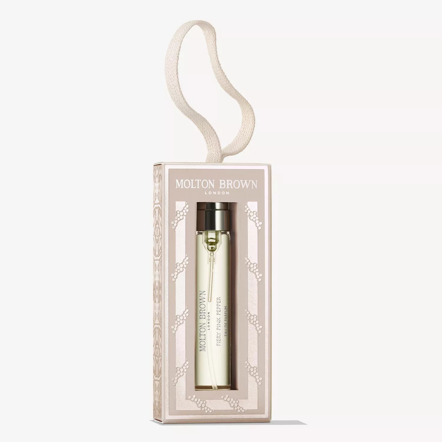 The MoltonBrown Cyprus Fiery Pink Pepper Fragrance Bauble 7.5ml comes in a light gold bottle with a hanging loop, beautifully boxed in elegant beige and white packaging.